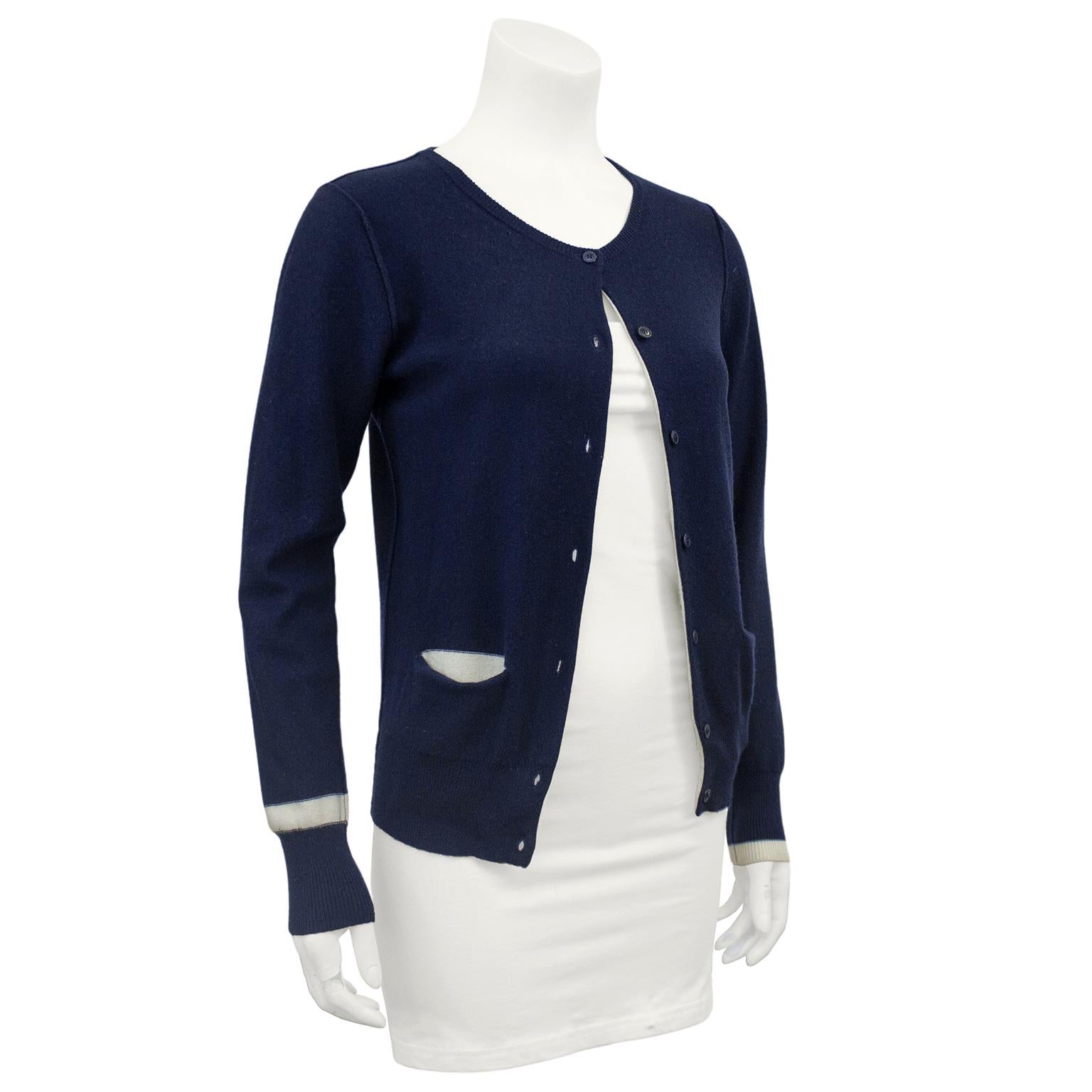 1980s Sonia Rykiel  cotton/cashmere blend knit cardigan. Navy blue with contrasting white at cuffs and interior of horizontal slit pockets. Crewneck with matching blue buttons. Ribbed cuffs and hem. Excellent vintage condition. Marked FR size 36 -