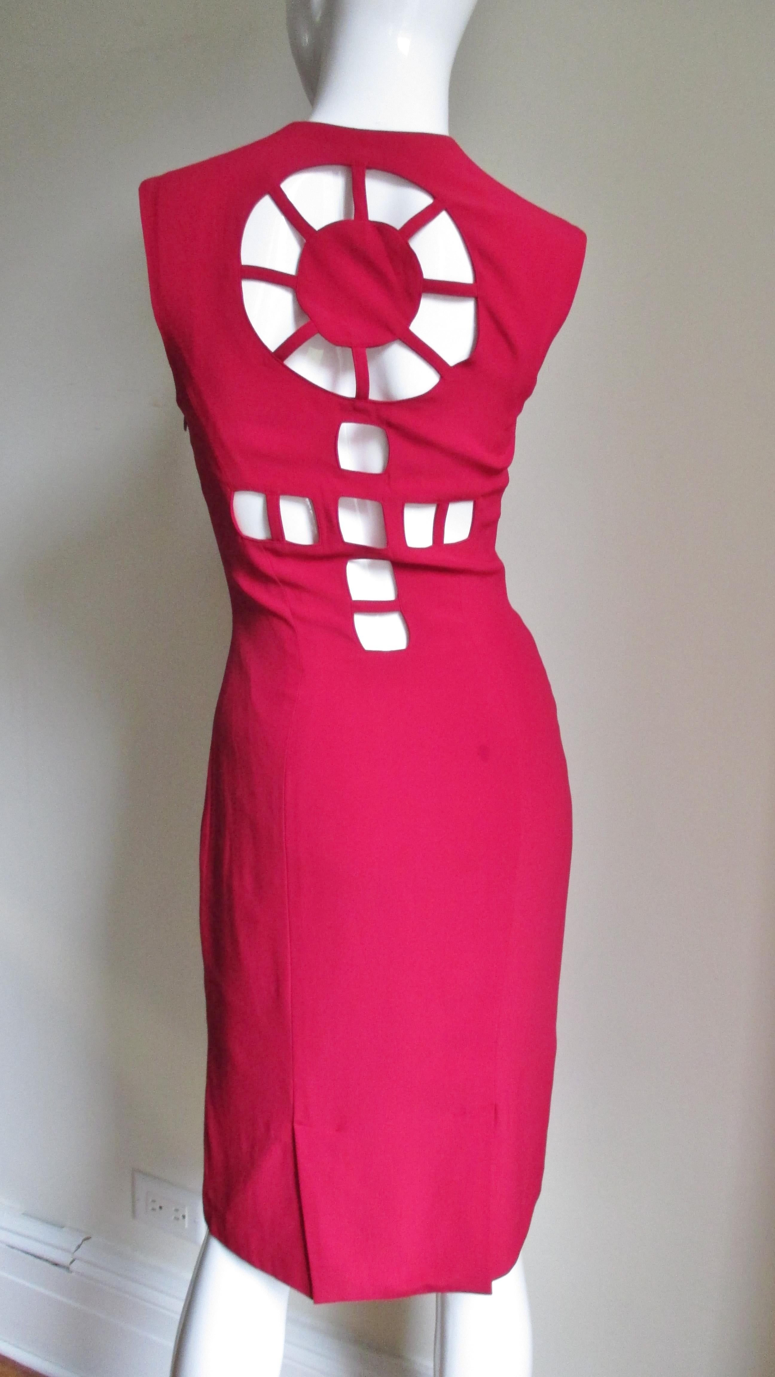 A gorgeous dress red from Sophie Sitbon   The sleeveless dress is fitted with princess seams and a square neckline.  The back is absolutely amazing with cutouts forming a circle at the upper back and cutouts forming a cross below that.  It is fully