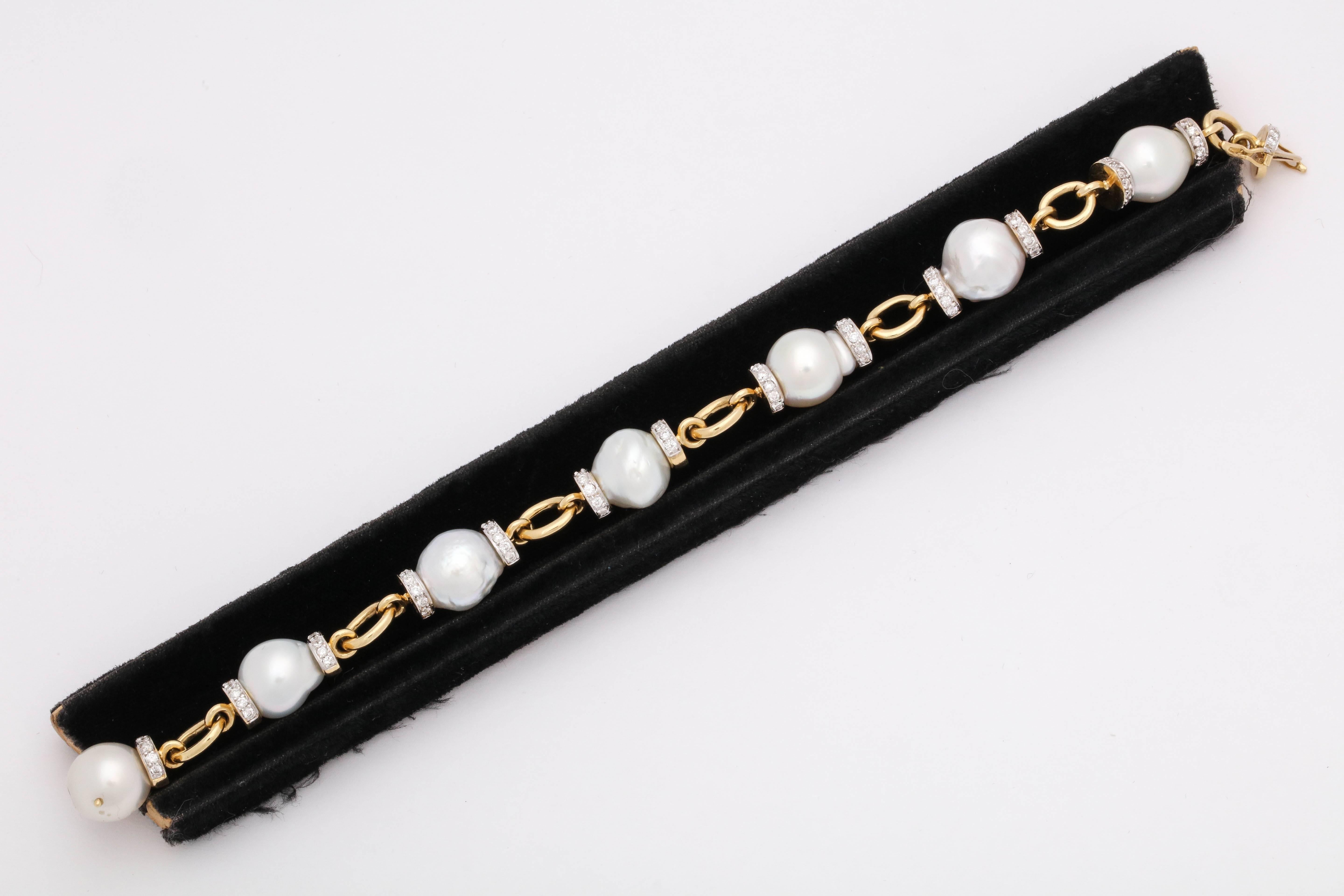 One Ladies Fancy South Sea Baroque Pearl With Diamond Link Bracelet Created In 18kt Yellow Gold. Composed Of Seven LargeSouth Sea Baroque Pearls Measuring Approximately 11Mm Each This Link Bracelet Is Further Designed With Fourteen Diamond Rondelles
