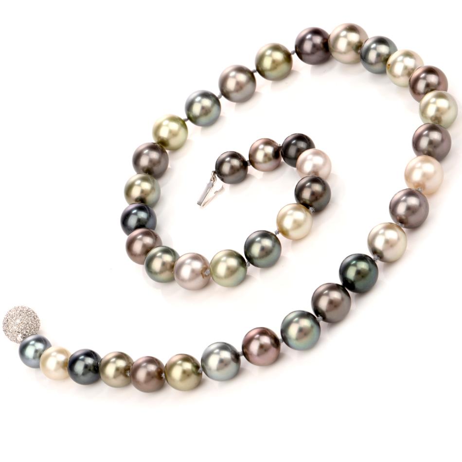 This very high quality lustrous South Sea peacock pearl and diamond strand necklace, weighs 80 grams and measures 19 inches long. Composed of 39 various colored creme to dark grey high quality AAA South Sea peacock pearls, ranging from  12mm - 10mm