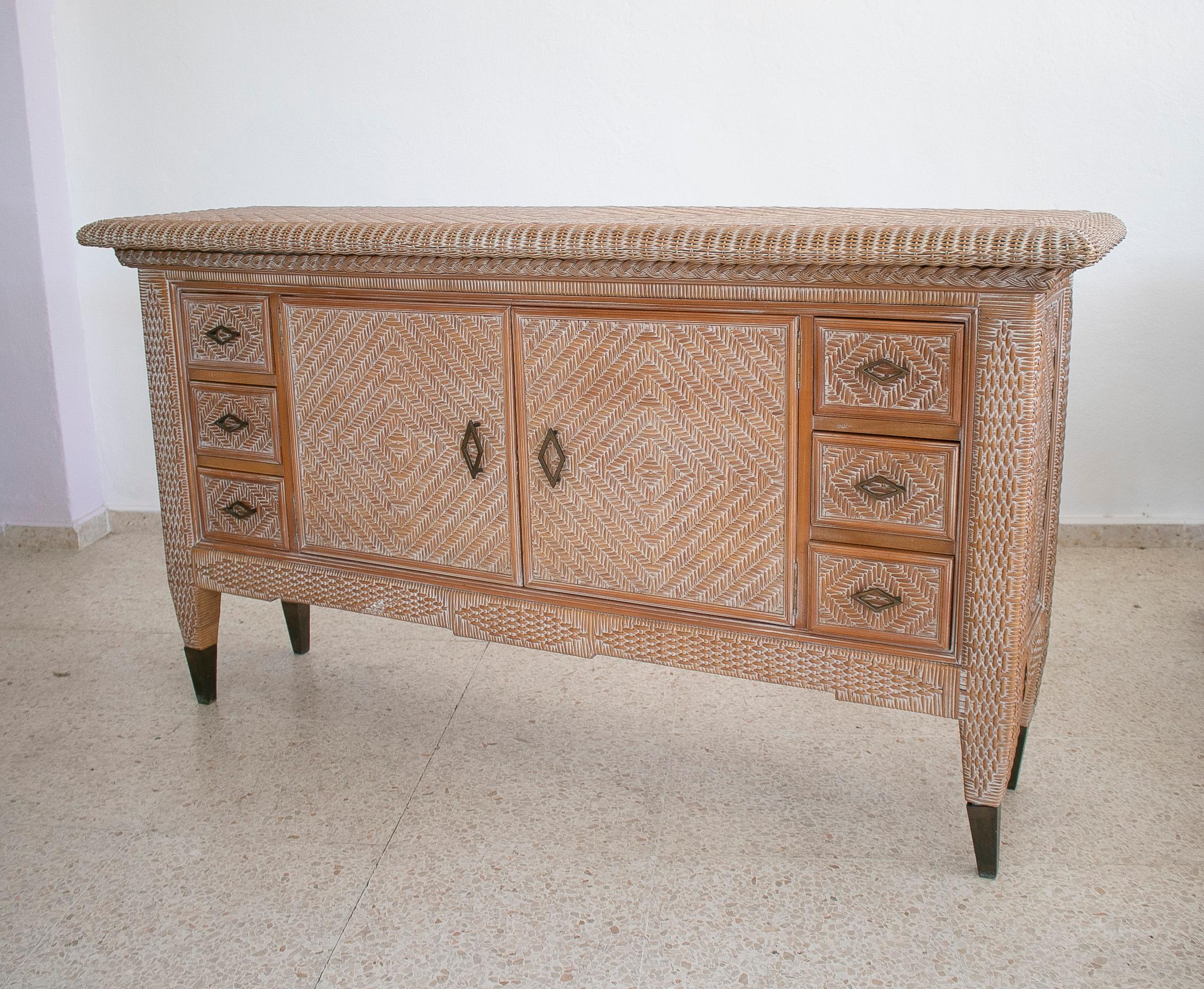 Vintage 1980s Spanish 6-drawer and 2-door woven wicker on wood side board.