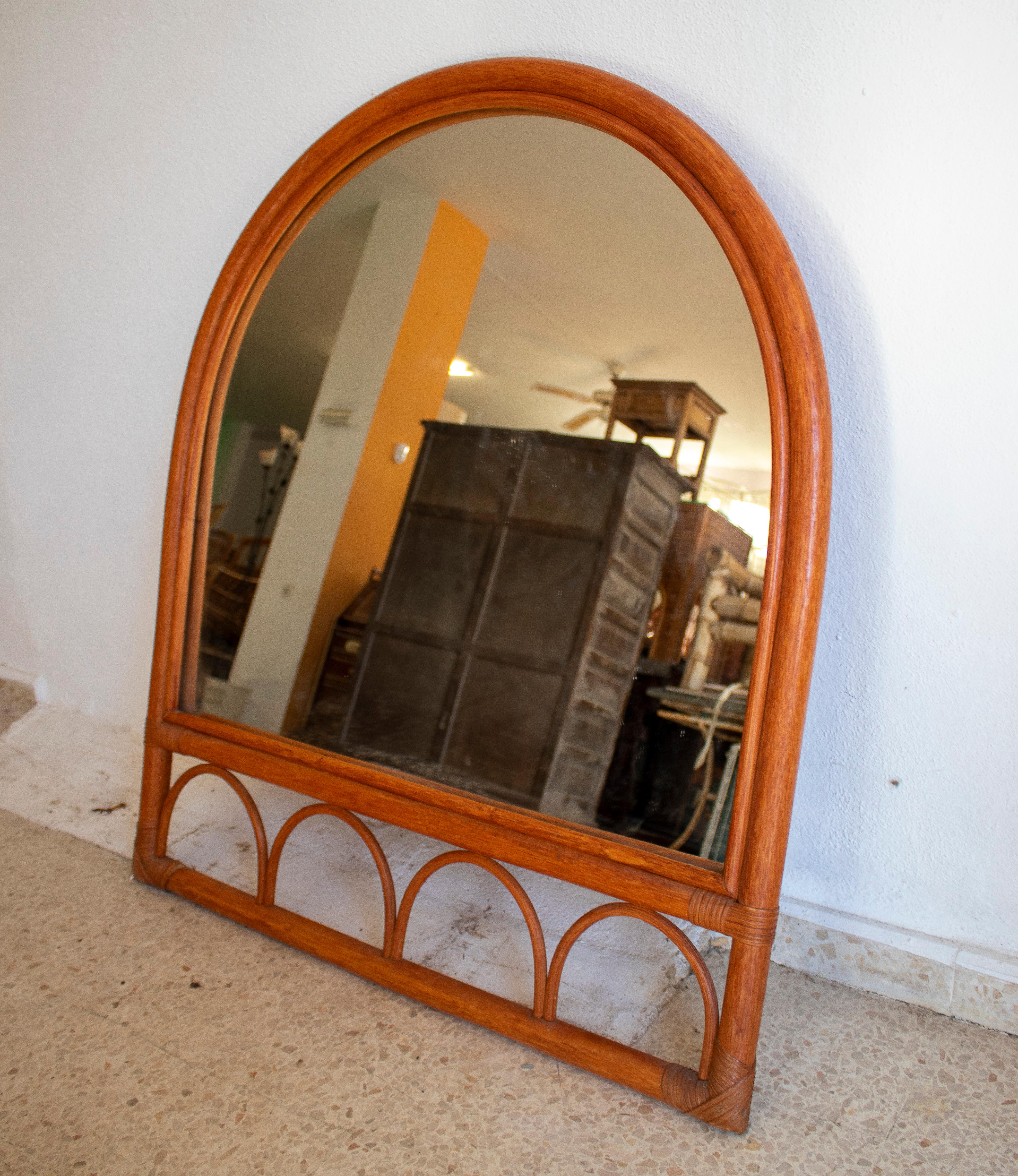 Vintage 1980s Spanish bamboo arched mirror.