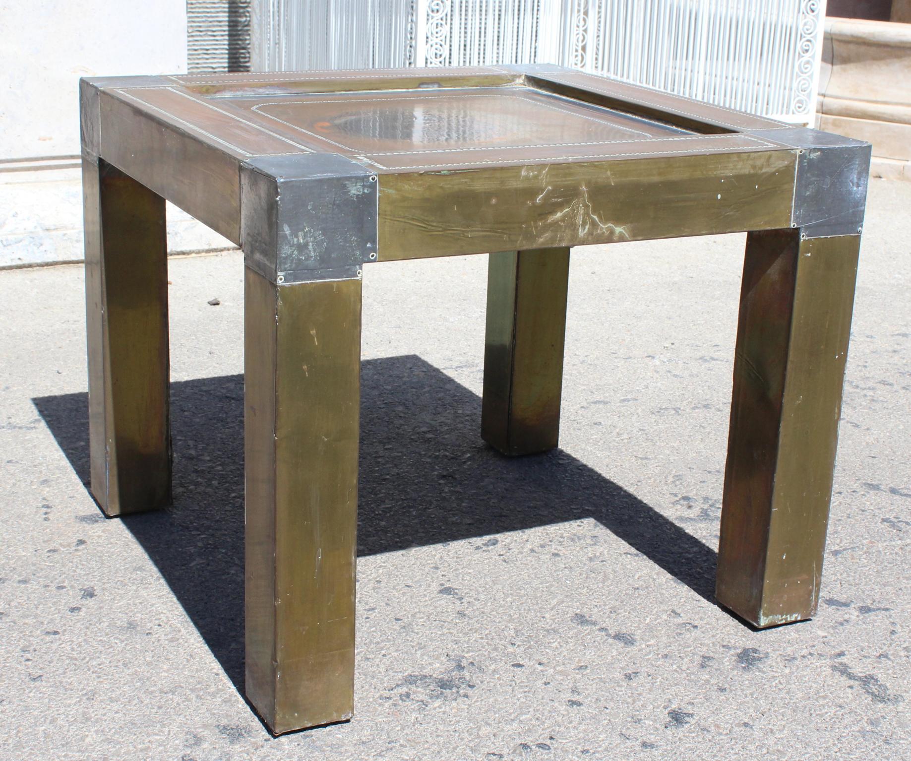 1980s Spanish brass side table with lead accent decorations in corners and frame.