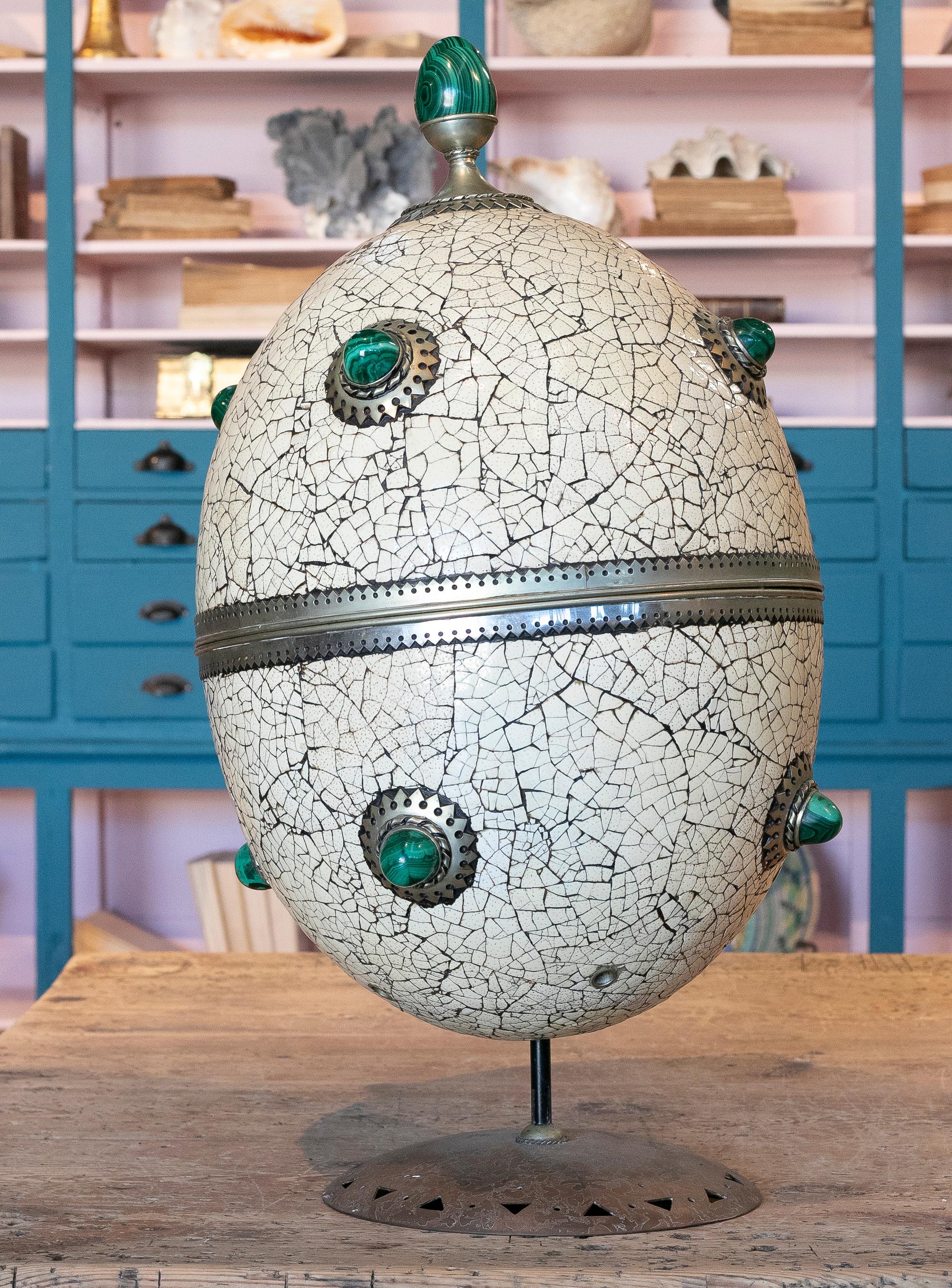 1980s Spanish giant decorative ostrich egg made with its own shell, bronze and malachite, on an iron pedestal.