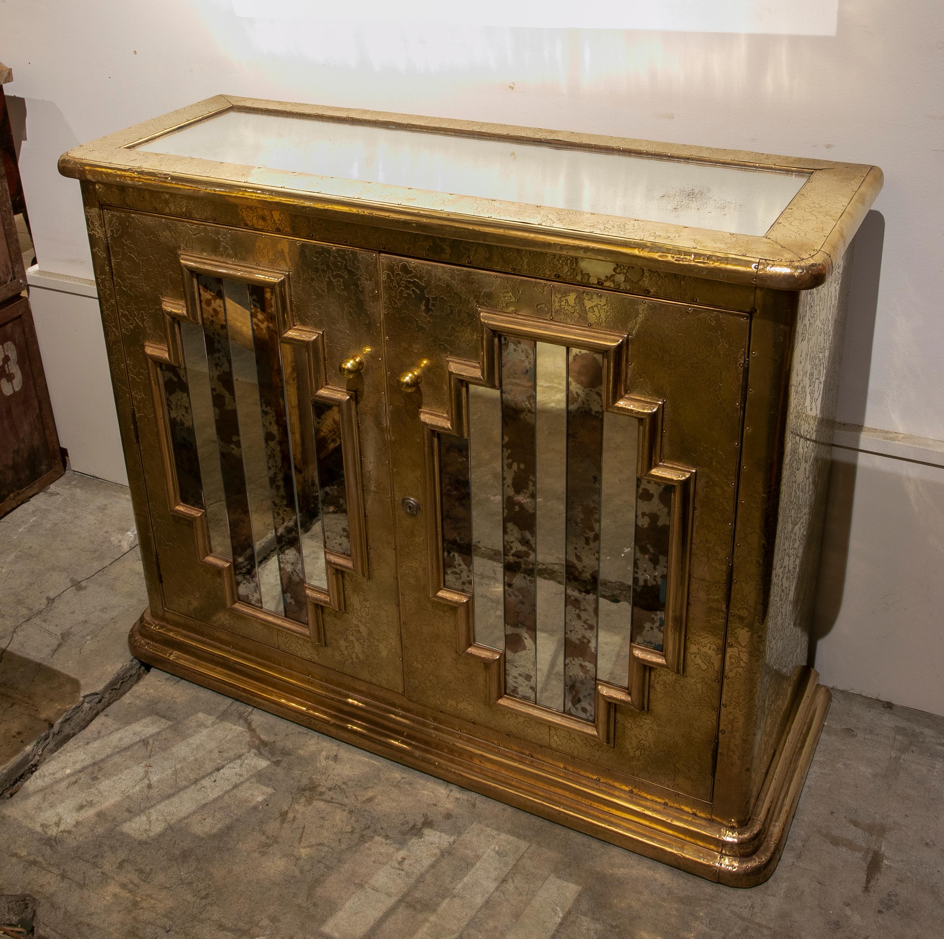 1980s Spanish console with brass doors and mirrors.