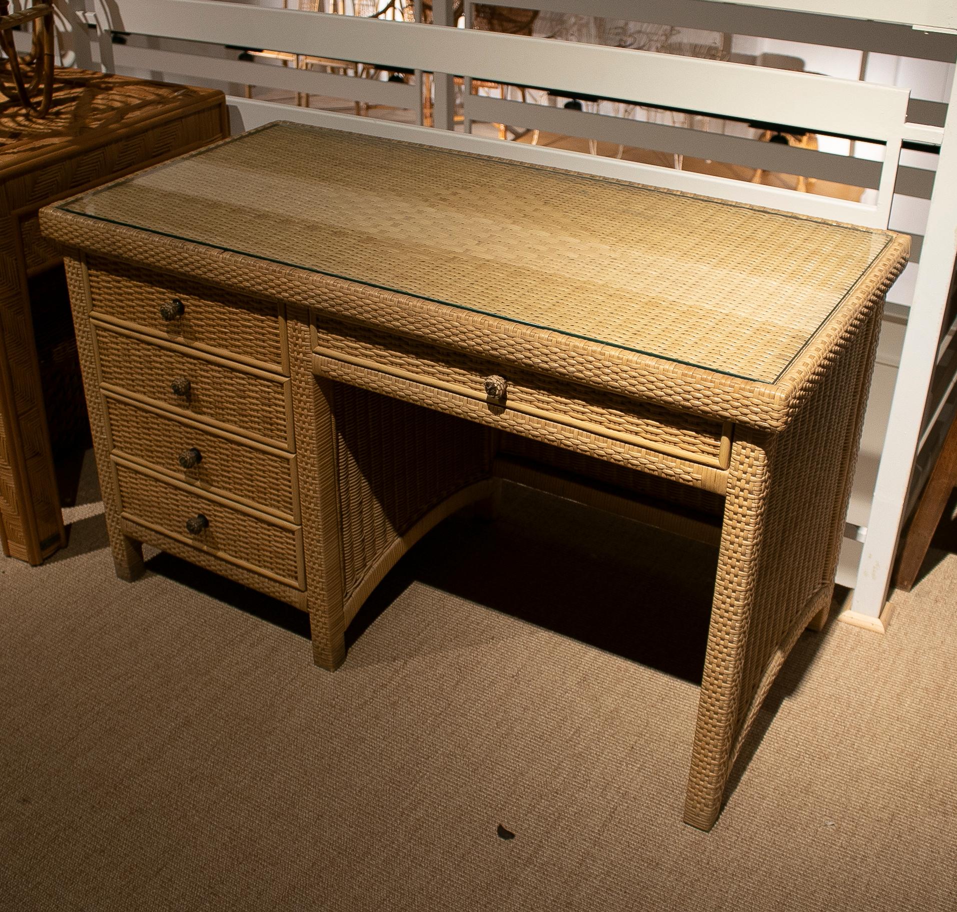 Vintage 1980s Spanish four drawer wood and wicker office desk with glass top.
