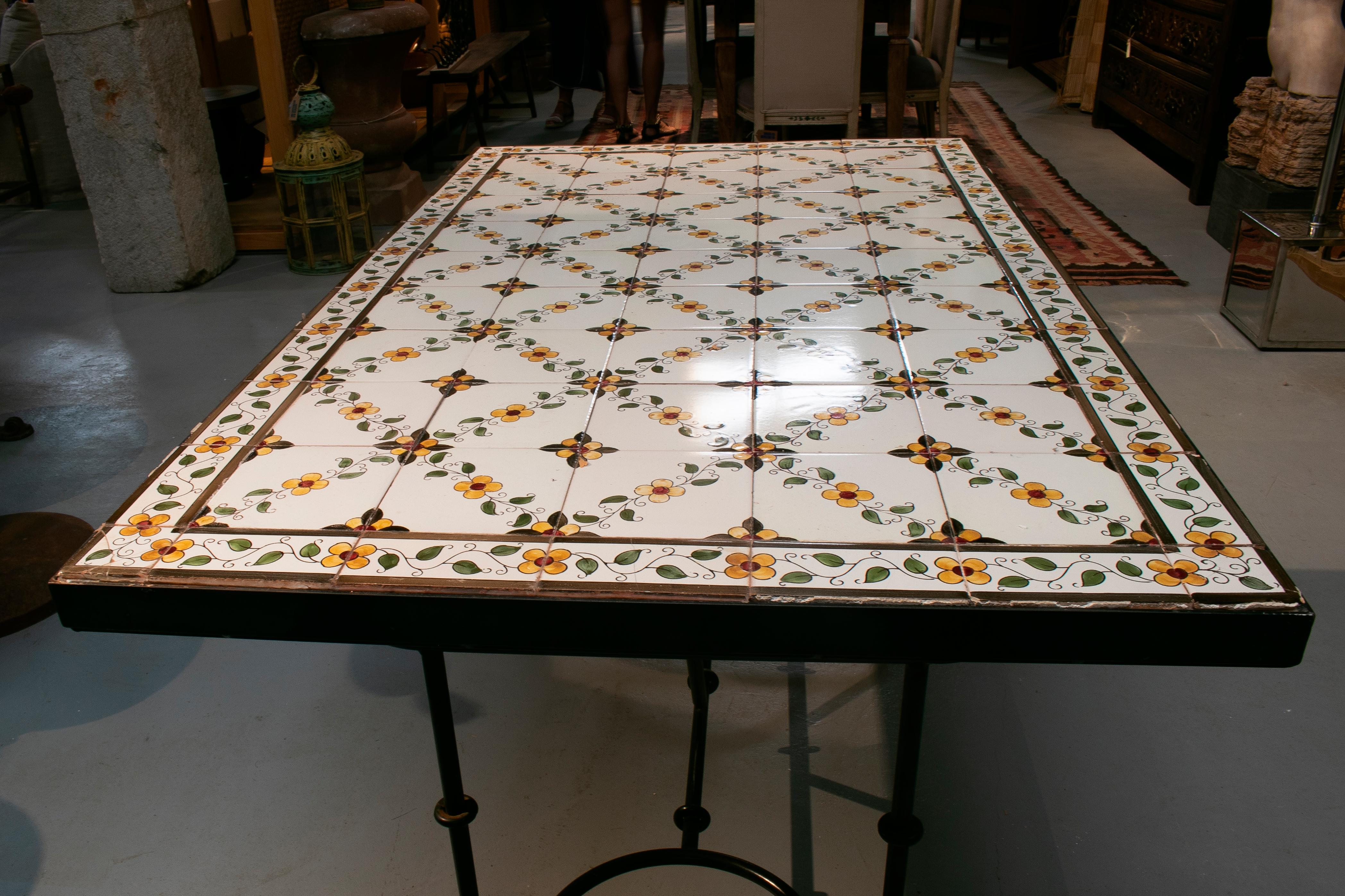 1980s Spanish glazed ceramic top kitchen iron table. Some tiles are cracked.