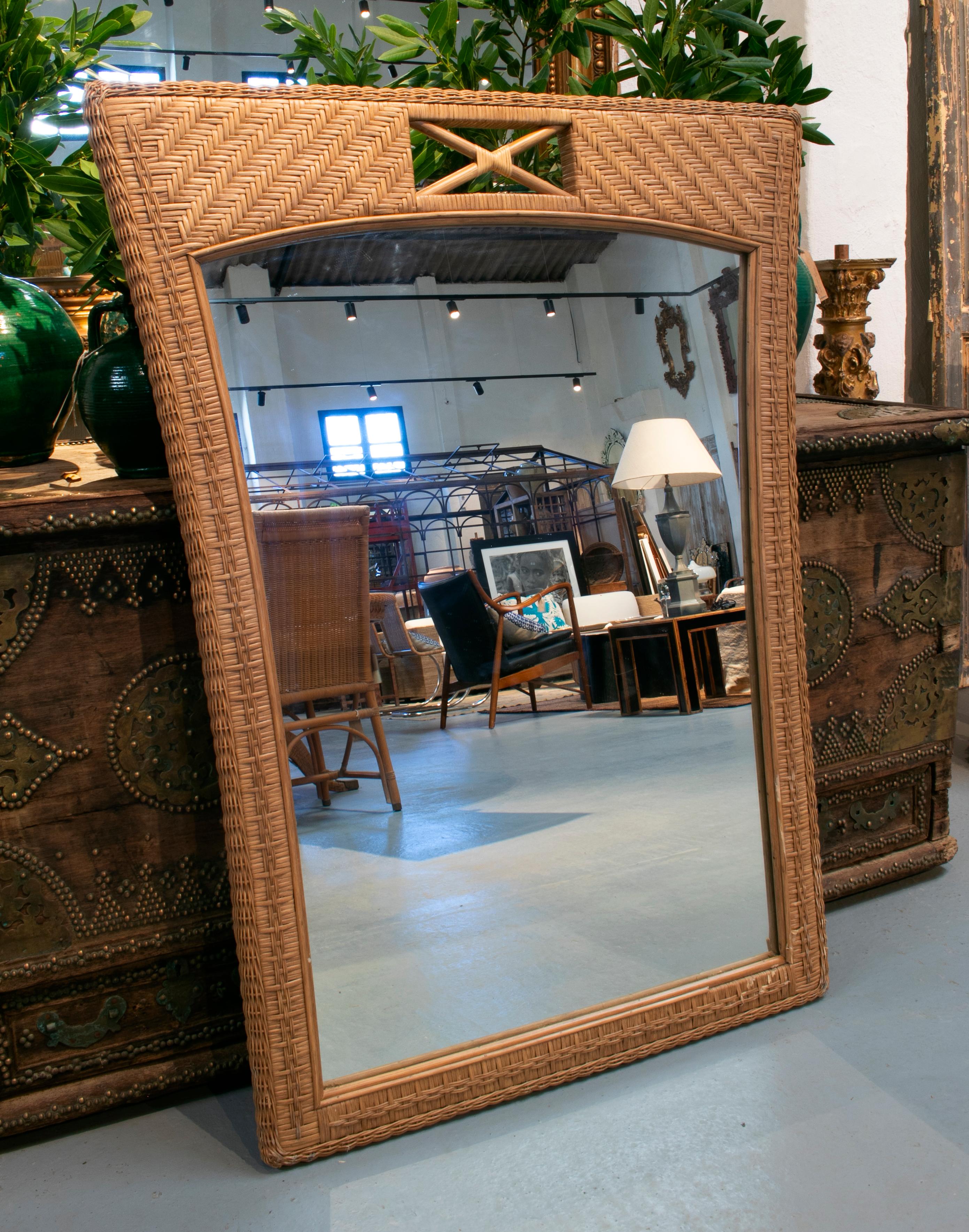 1989s Spanish hand woven brown wicker mirror.