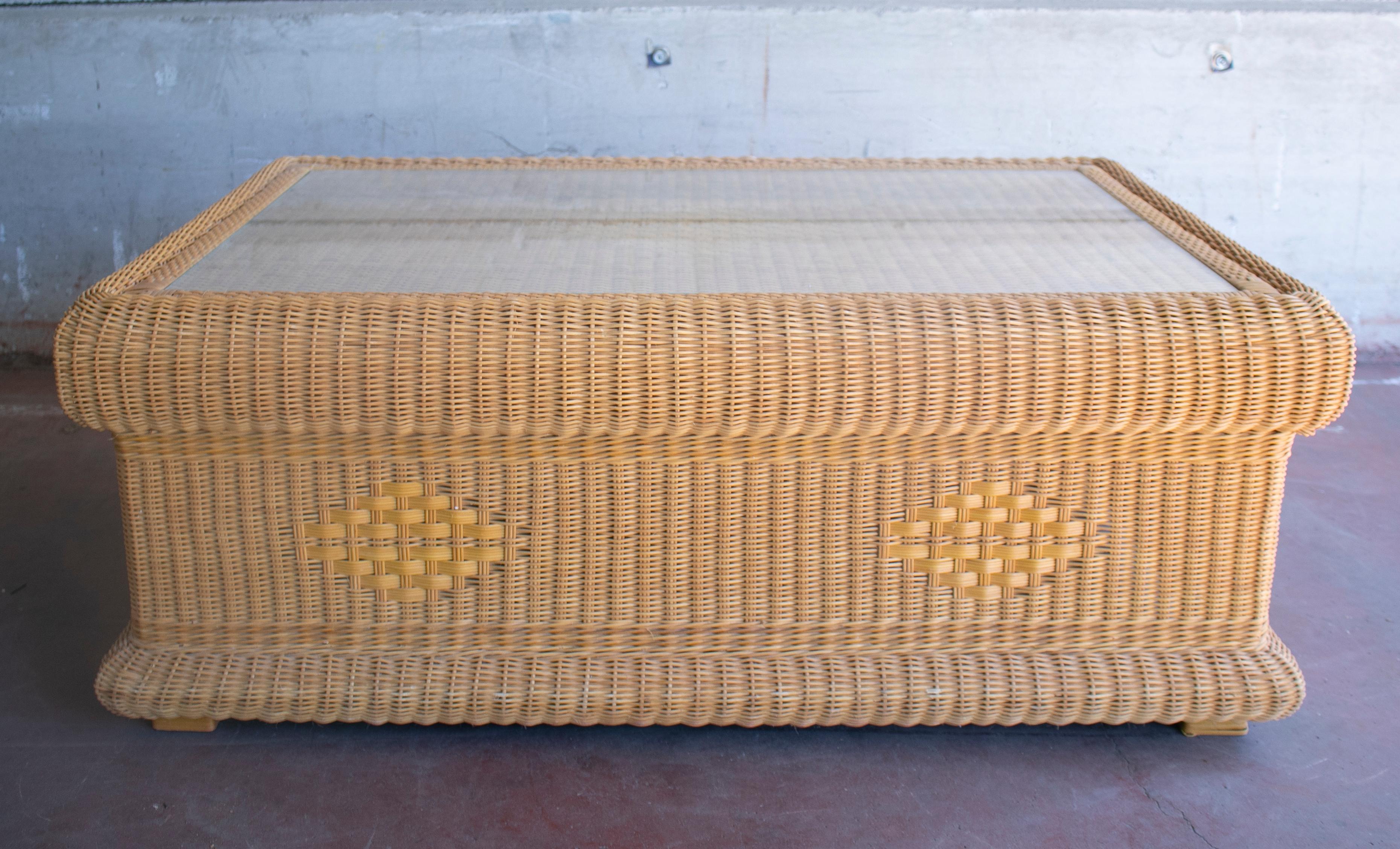 1980s Spanish hand woven wicker coffee table with glass top.
