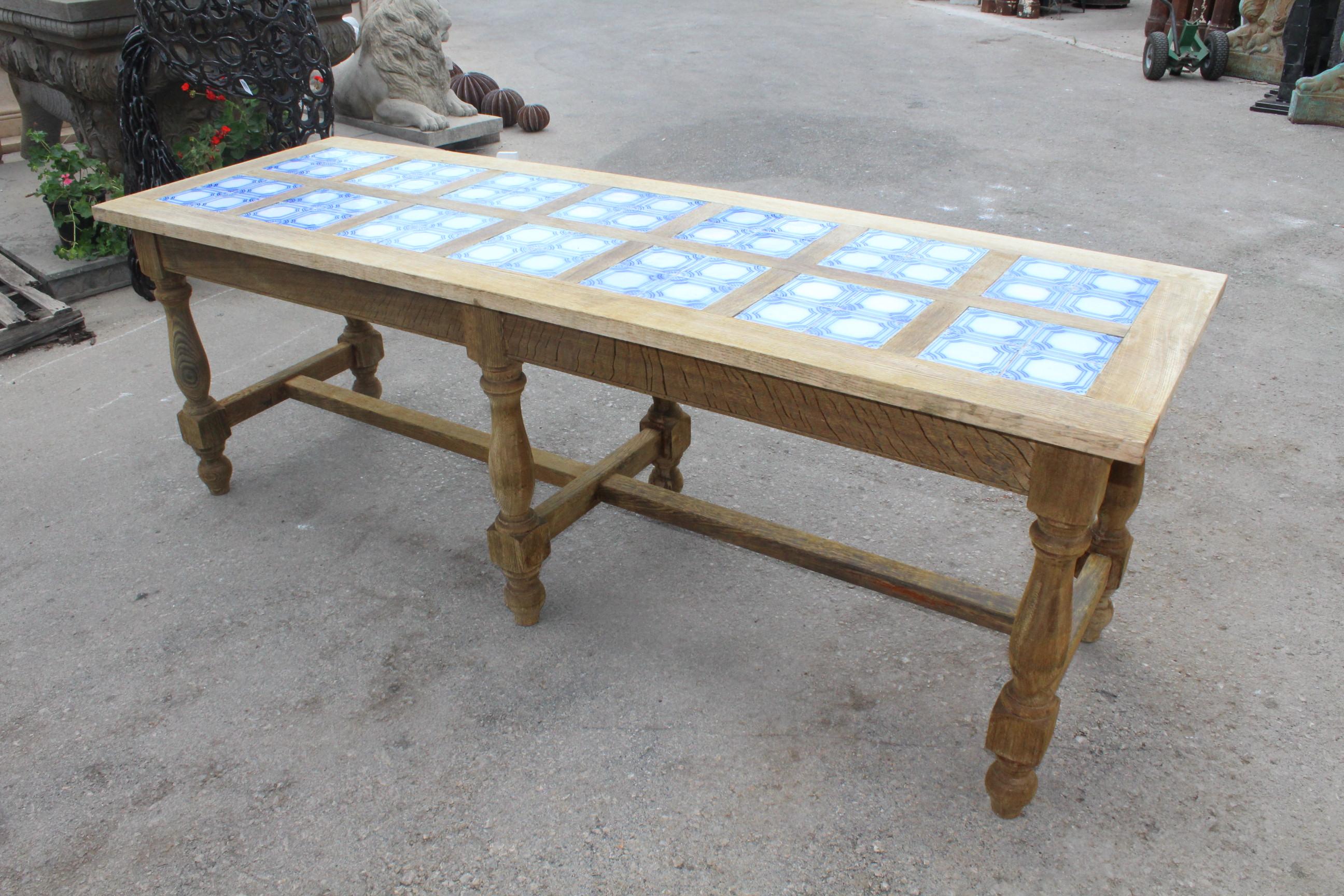 1980s six legged Spanish kitchen table with glazed ceramic tiled top and two drawers at opposite ends. 


 