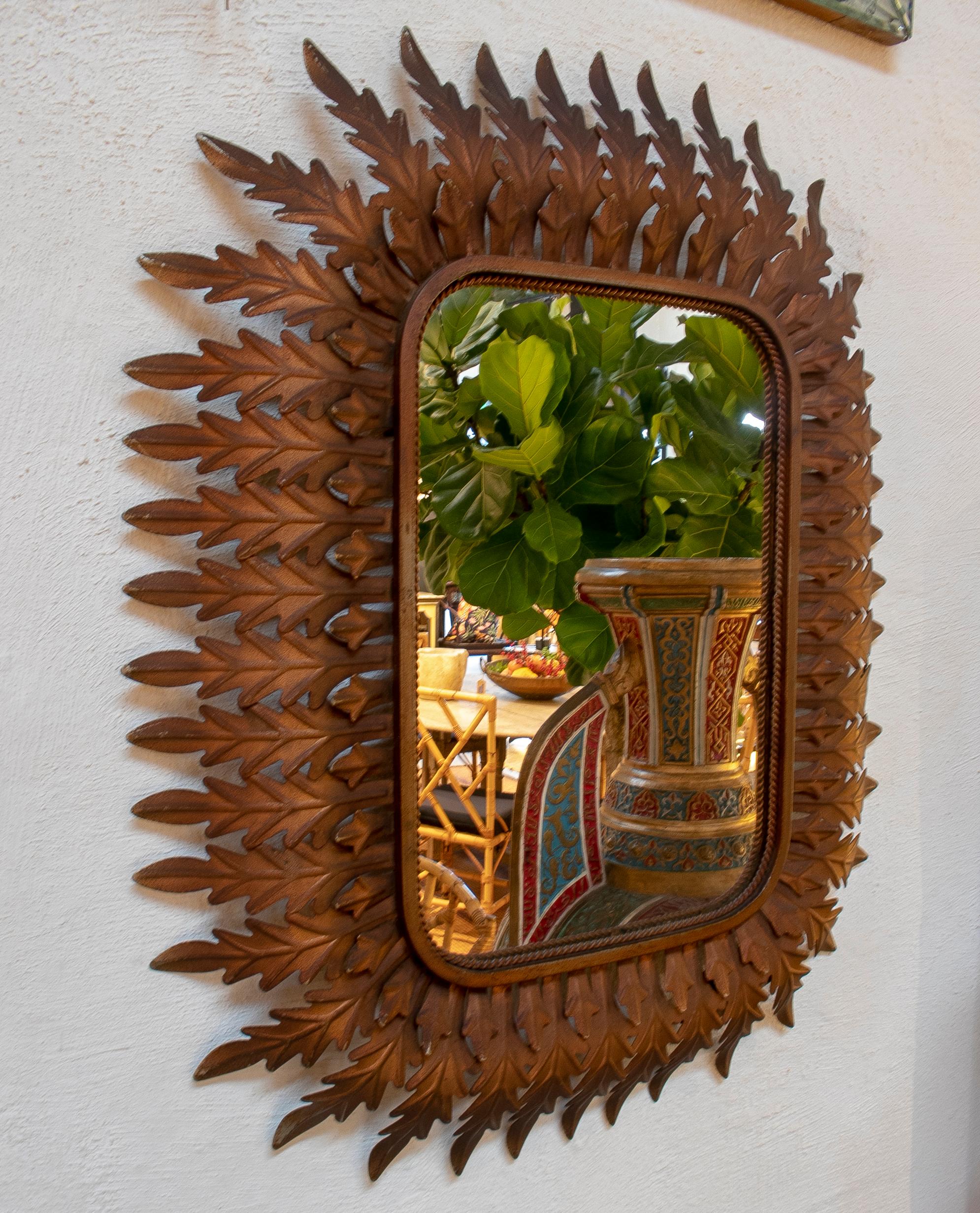 1980s Spanish mirror with acanthus leaves decorated iron frame.