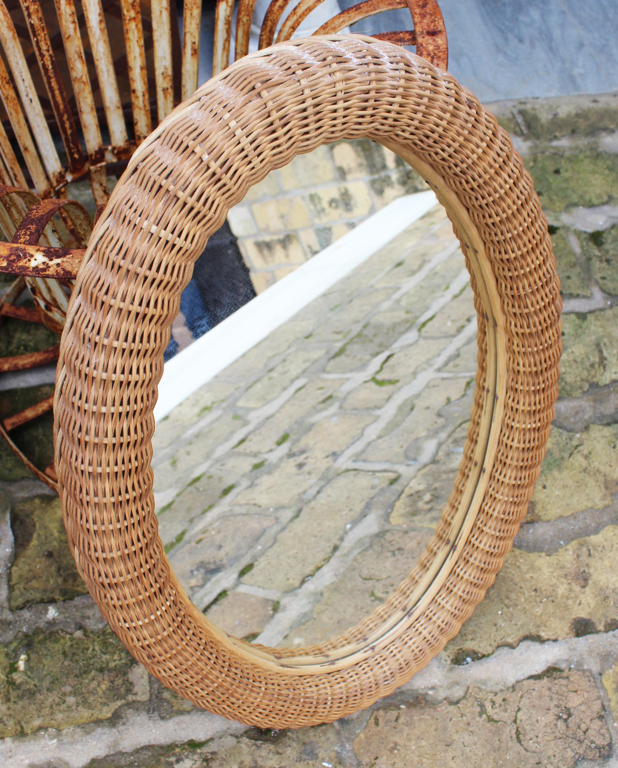 1980s Spanish handcrafted oval wicker frame mirror.