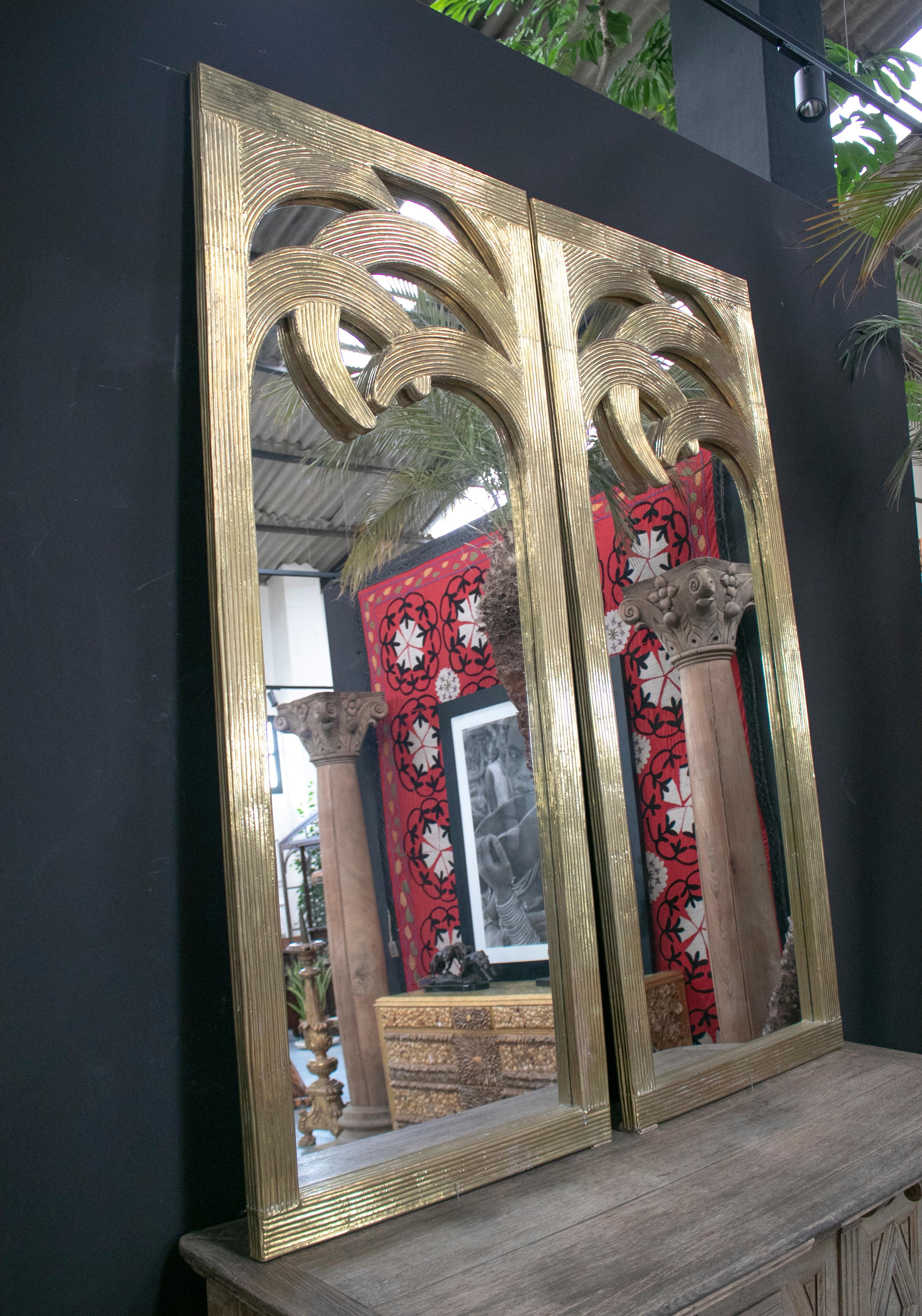 1980s Spanish pair of palm shaped bronze-plated wooden mirrors.

Dimensions each: 200 x 90 x 4 cm.