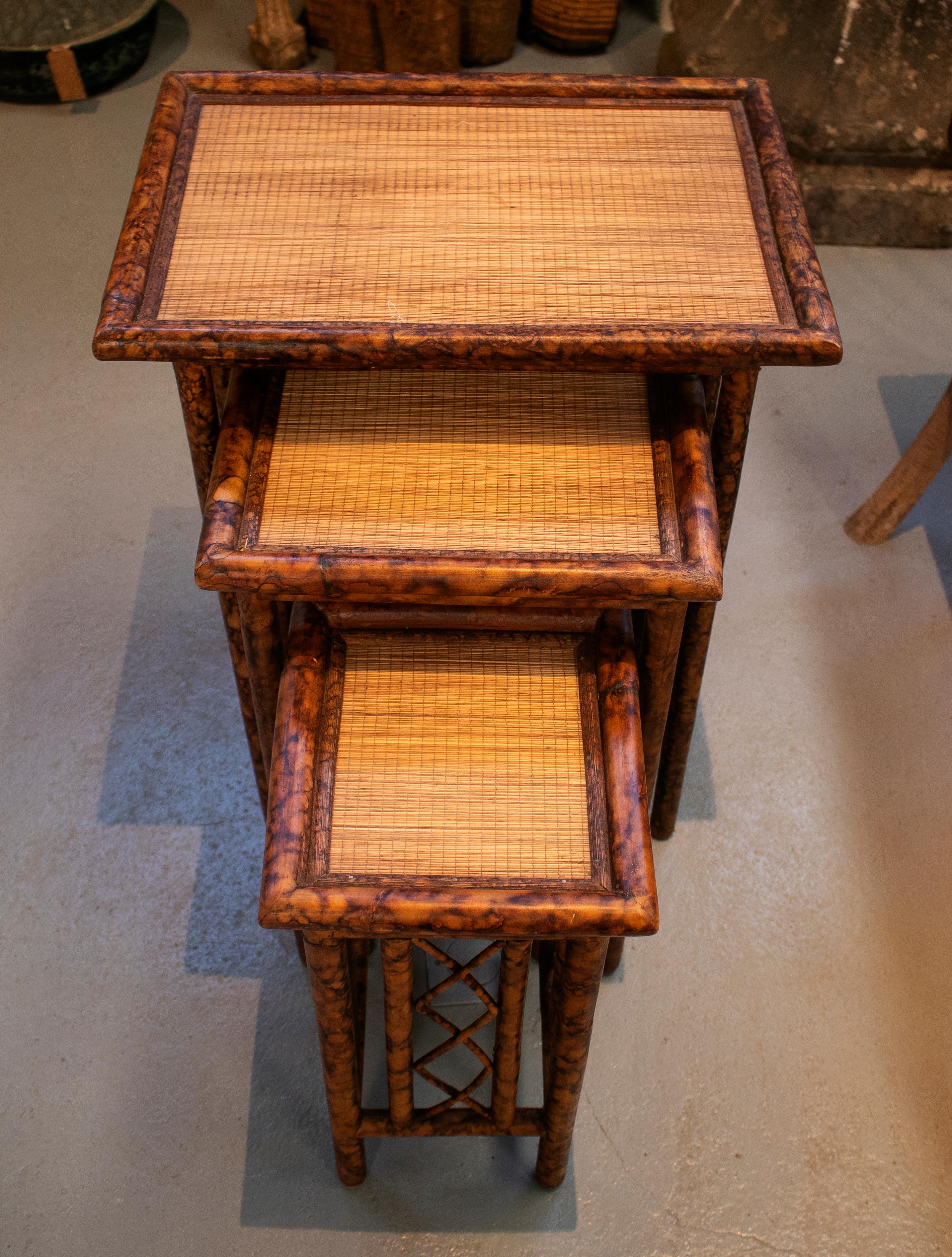1980s Spanish set of three bamboo and rattan nesting tables.