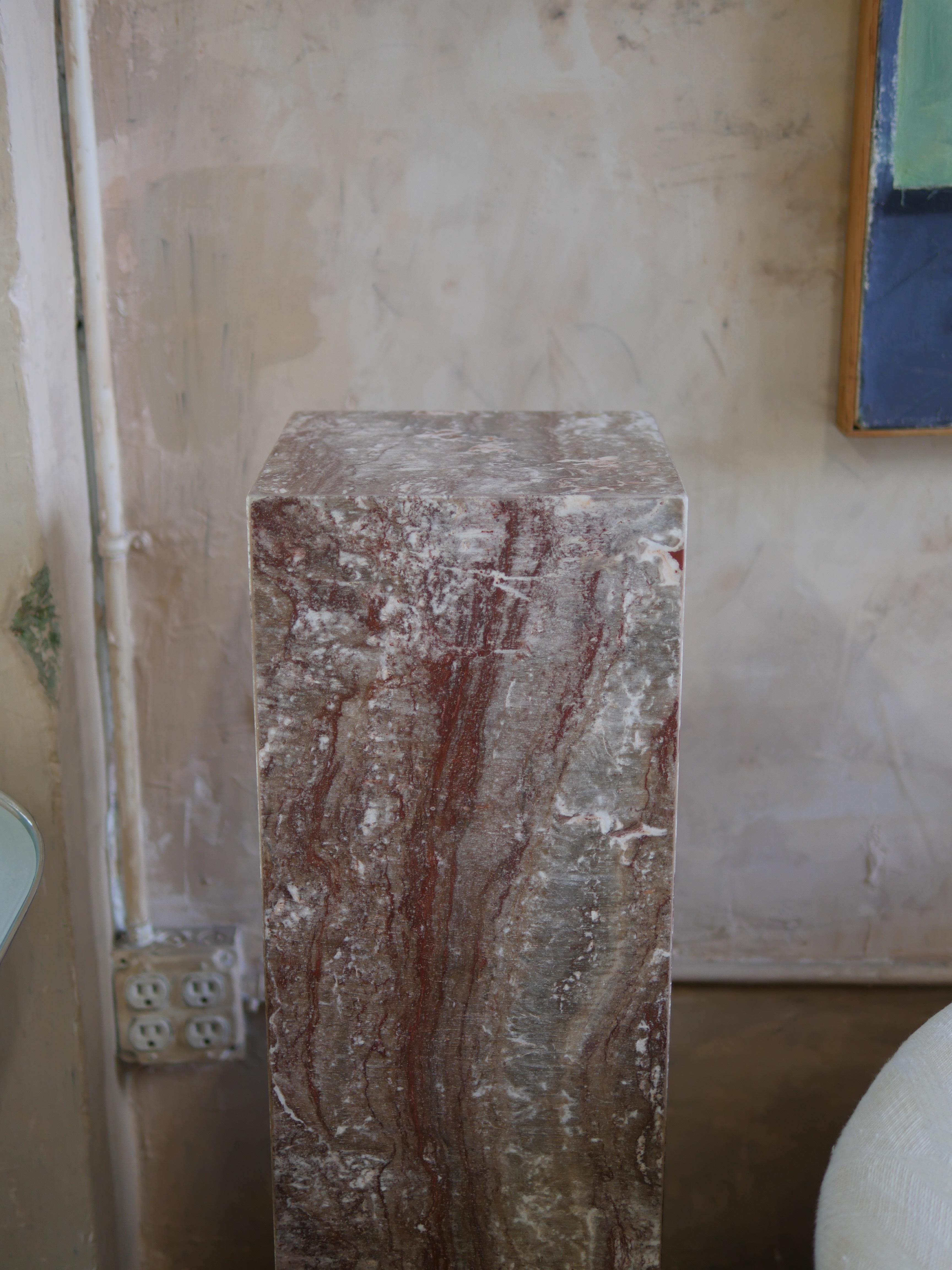 Beautiful 1980s red and gray polished, Spanish postmodern travertine pedestal. This is exotic pedestal is perfect for displaying your favorite sculpture, plant and adding a nice touch of character to the room. 