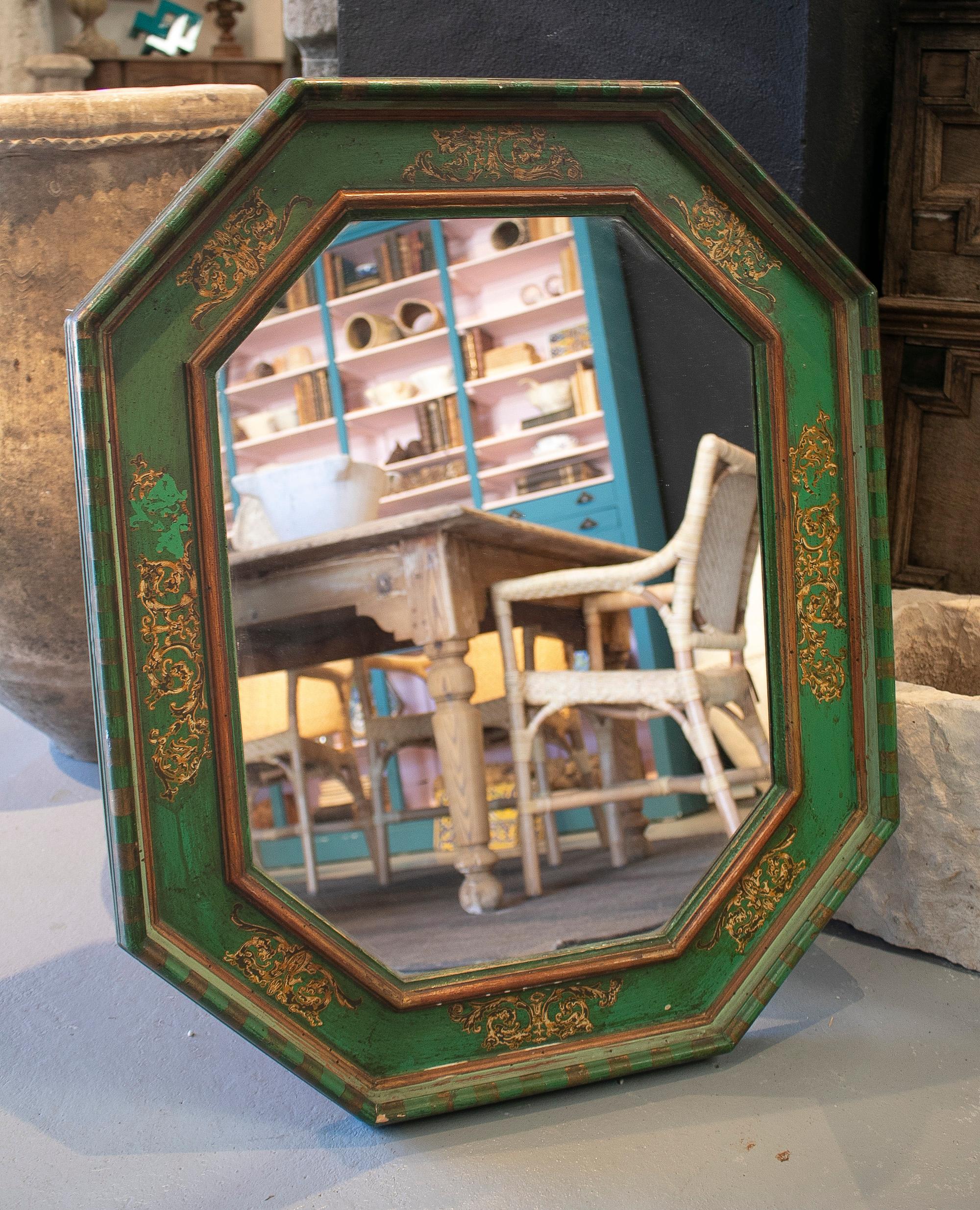 Vintage 1980s Spanish wooden wall mirror with green and gold painted frame.
 