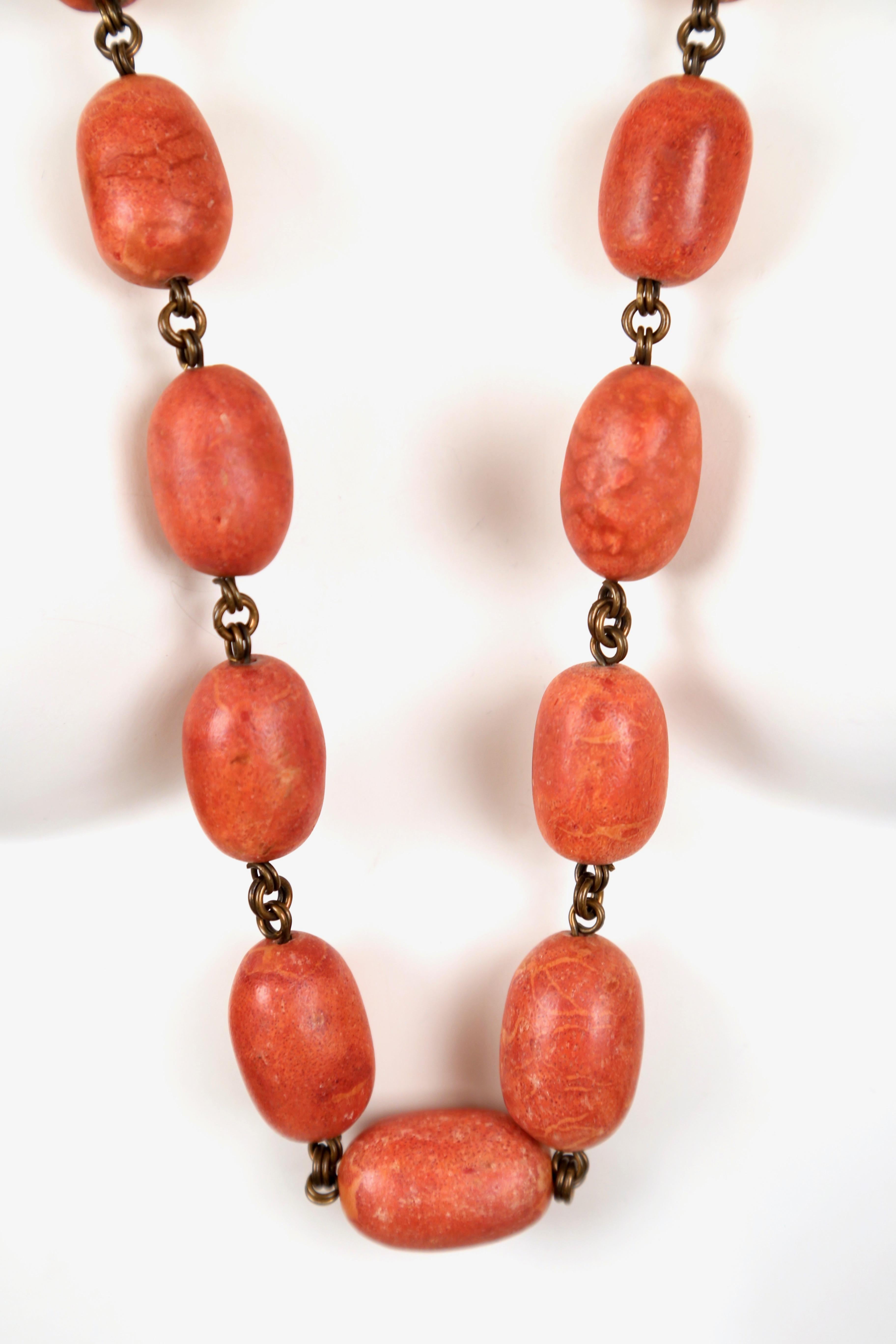 Long oversized apple coral beaded necklace on bronze chain designed by Stephen Dweck dating to the late 1980's purchased at Bergdorf Goodman. Necklace measures approximately 37