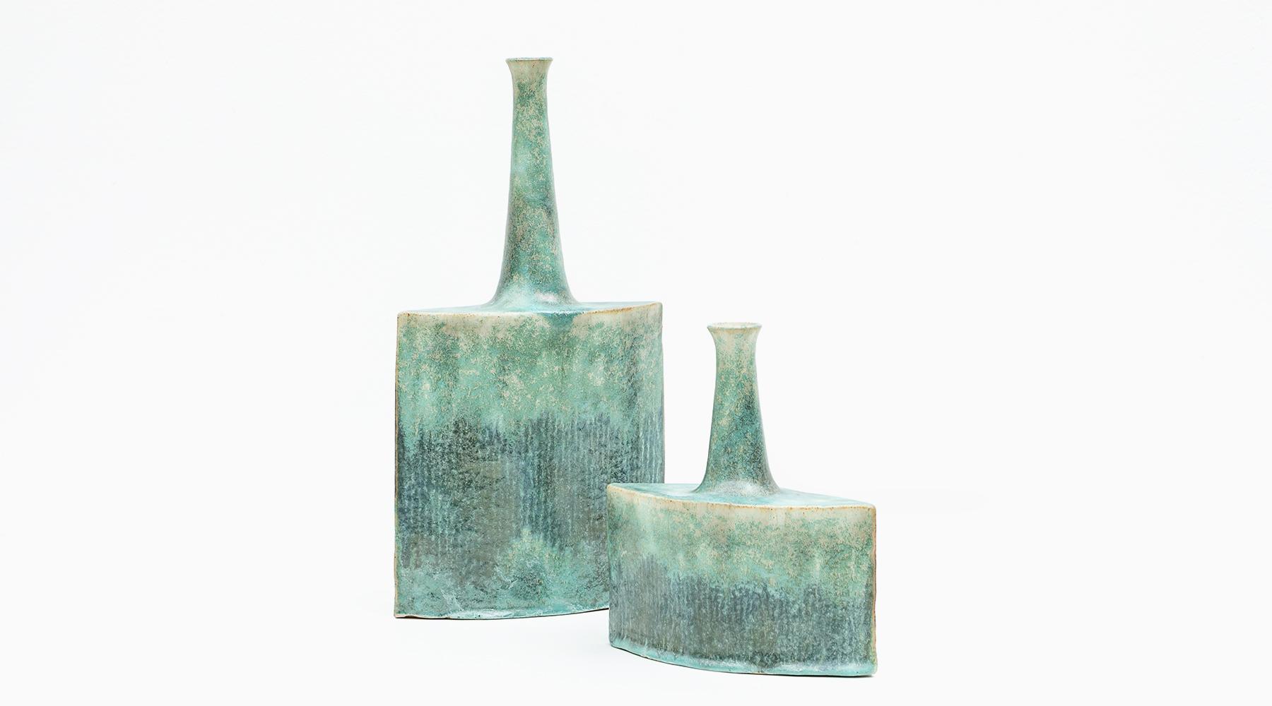 Art pottery in sea tones, set of two vases, ceramic, Bruno Gambone, Italy, 1980s.

Lovely set of two vases by the versatile artist Bruno Gambone from the 1980s, different heights but visually the same width. The ceramic objects have a narrow neck
