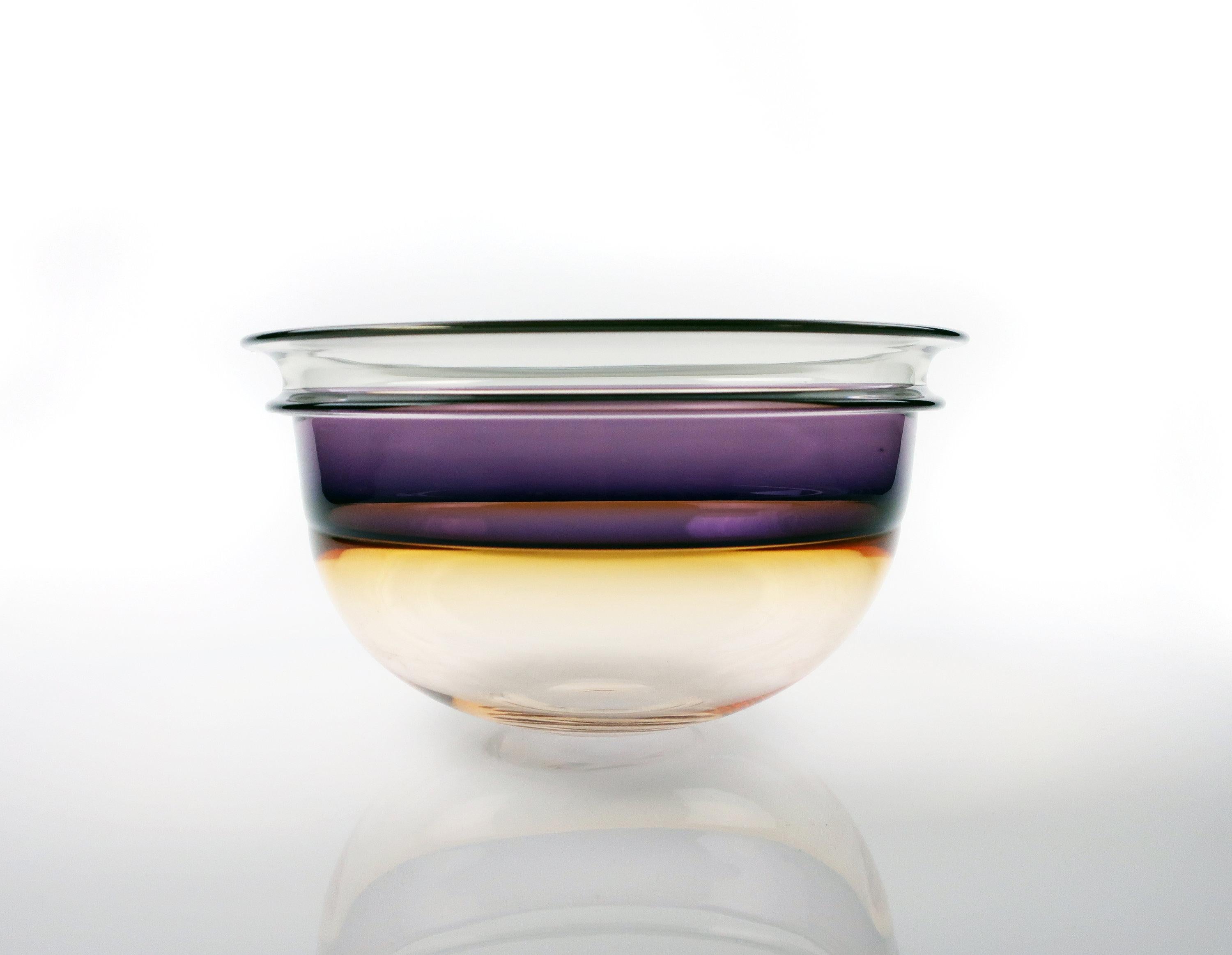 Post-modern blown glass bowl by renowned East Coast master Art Reed. This studio art glass blow has a clear base that transitions to orange below a vibrant purple band and a clear rim. Contemporary, modern, and stunning!

In excellent condition