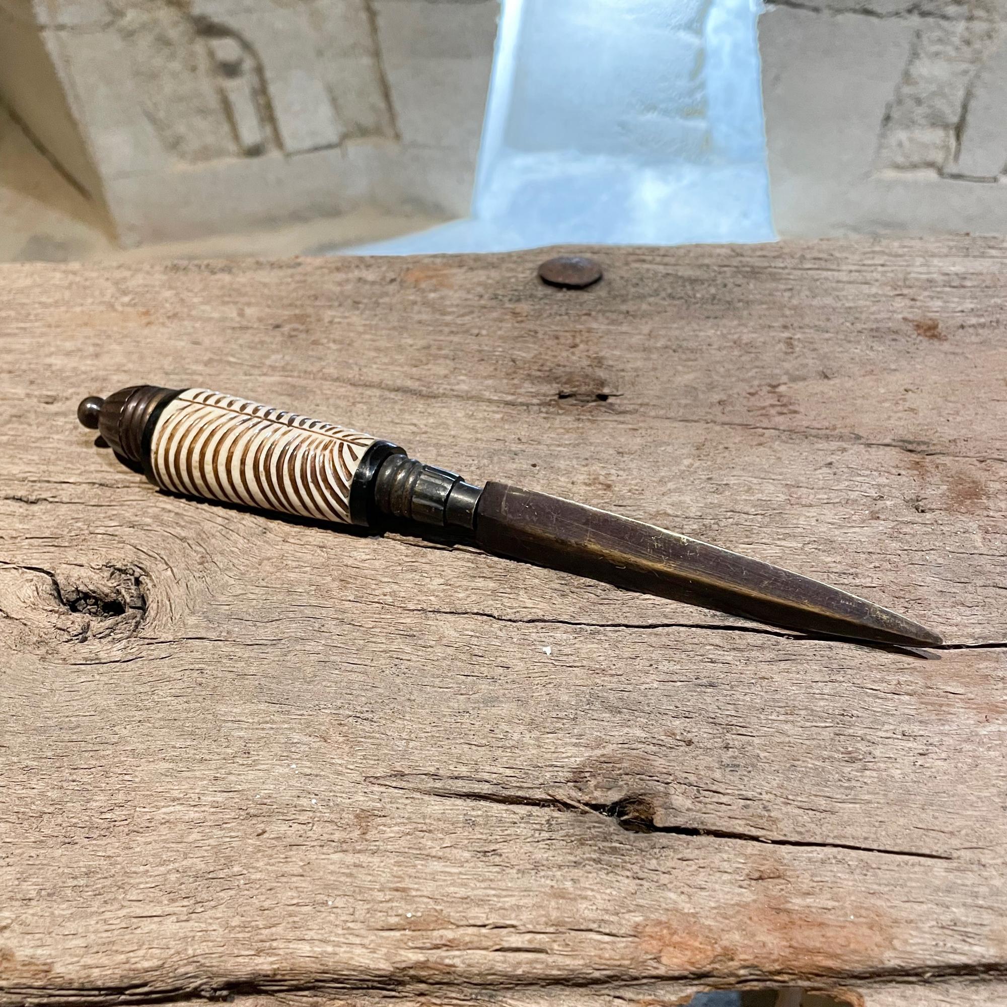 1980s stylish dagger in bone and bronze vintage letter opener with African motif
Measures: 9.25 L x 1.38 x 1 inches
Unrestored vintage condition original presentation.
Please see images.
  