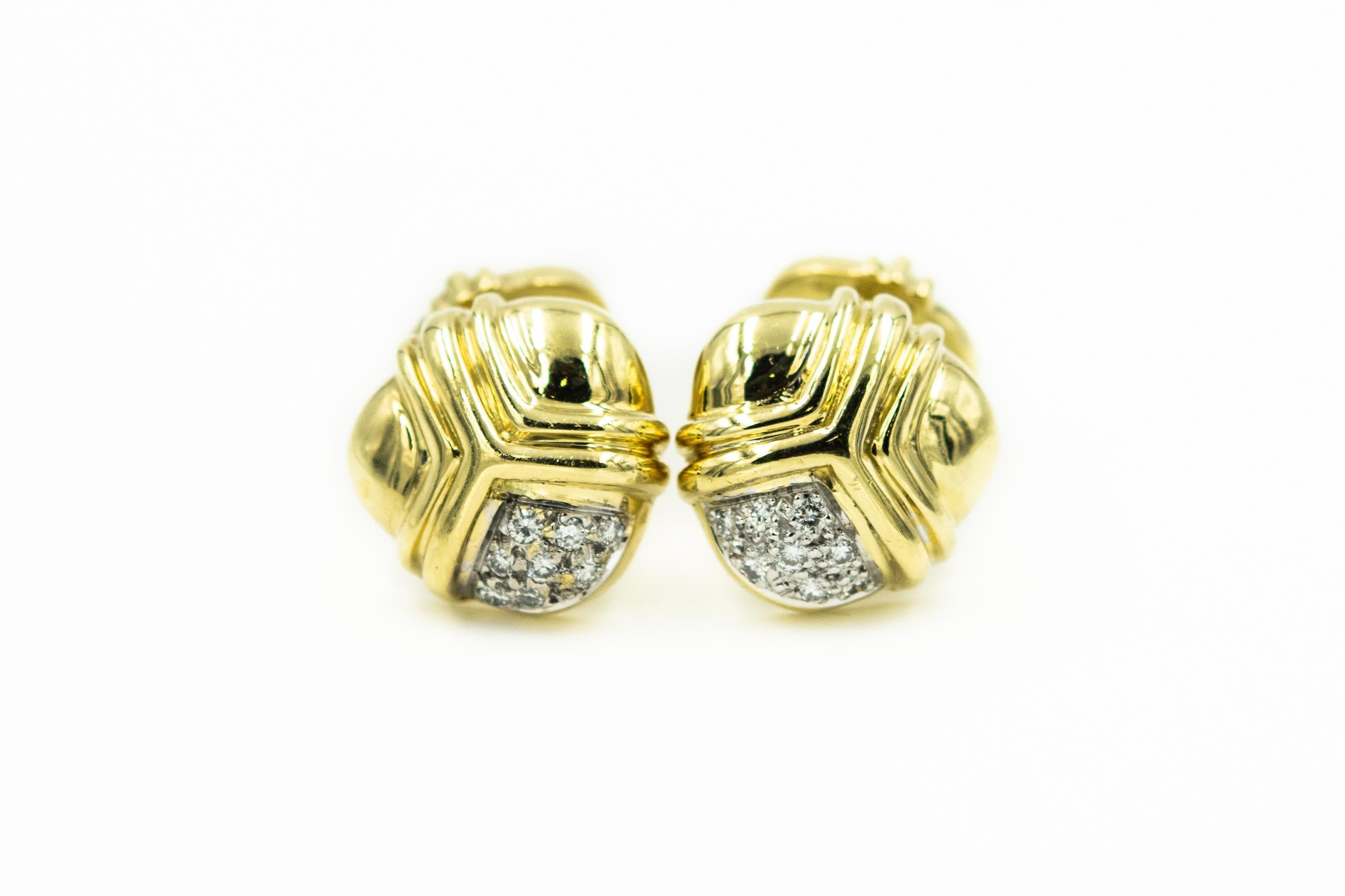 Stunning late 20th century 18k yellow and white gold cufflinks and tie tac set by Cassis. The set features a highly stylized three dimensional design with 3 sections that are divided by 3 lines.  Each piece has eight diamonds in one section with a