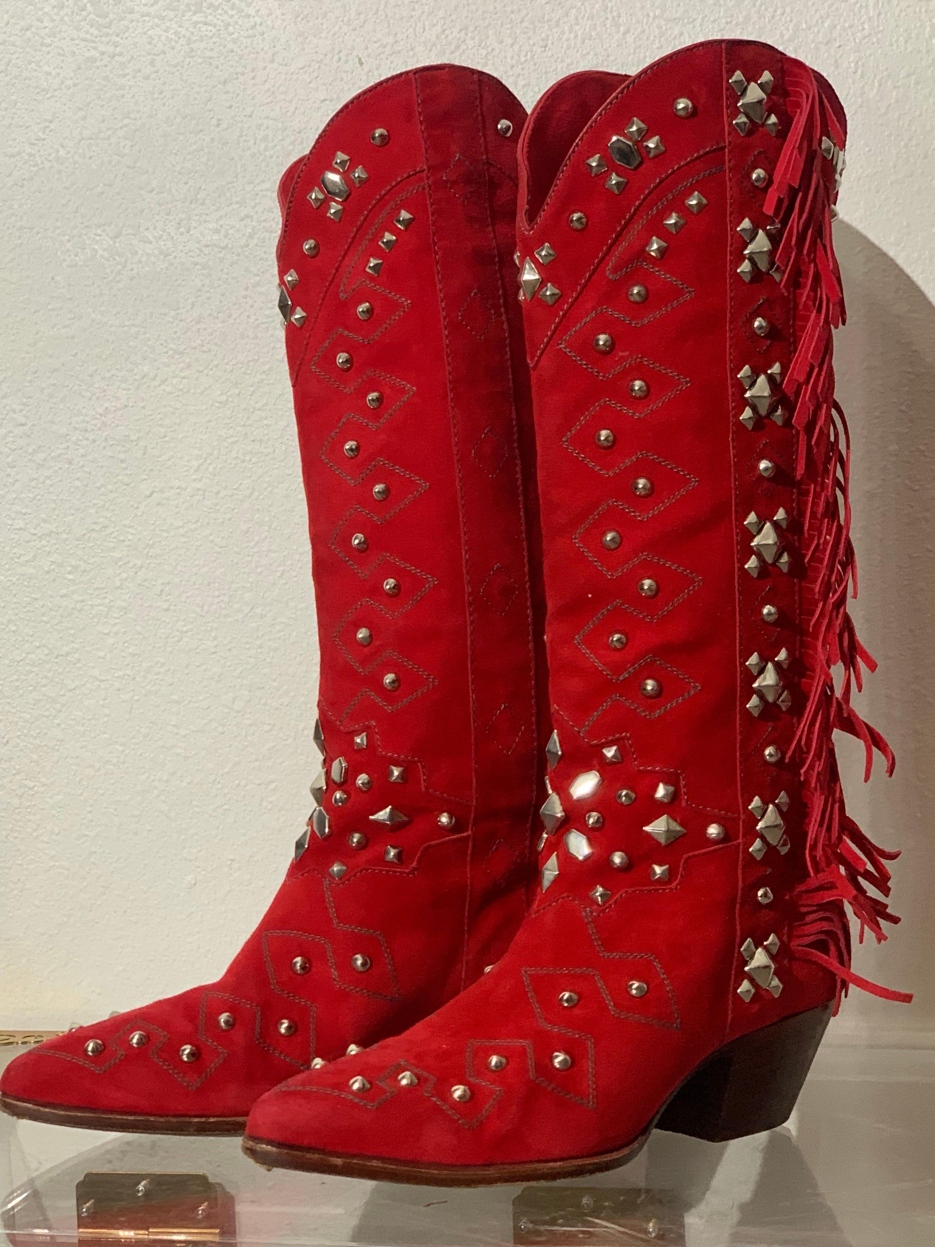 1980s Susan Warren Edwards Red Suede Fringed and Studded Cowboy Western Boots:  Tall and narrow, these boots make a stunning entrance with their vivid red and generously studded design. Soft pointed toe and a high stacked heel. Hand-made