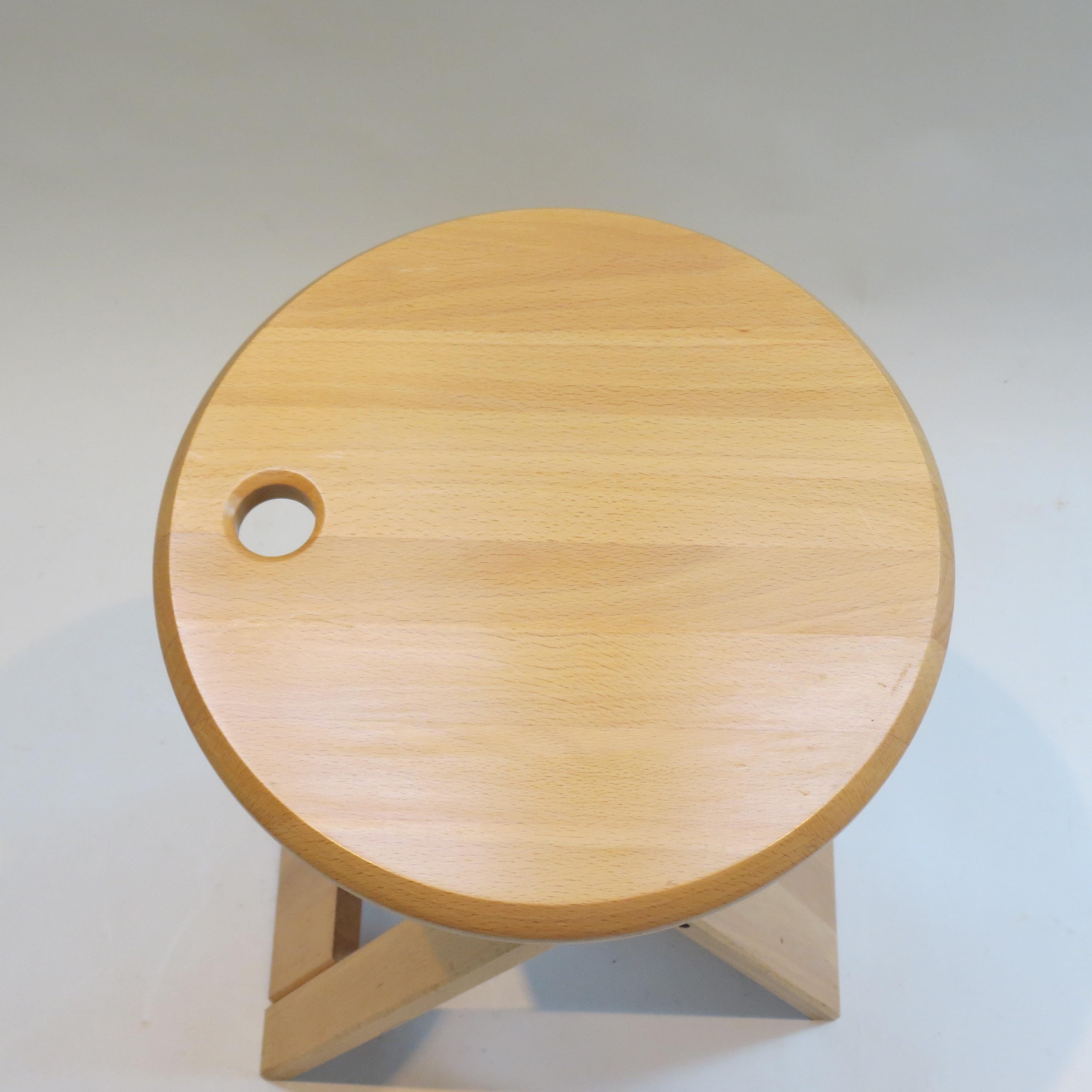 “Suzy” stool, designed by Adrian Reed 1984/1985 and manufactured by Princes Design Works Ltd.  This stool was available in two sizes, this is the taller version.

Made from solid Beech with plastic/rubber hinges. The stools fold flat when not in