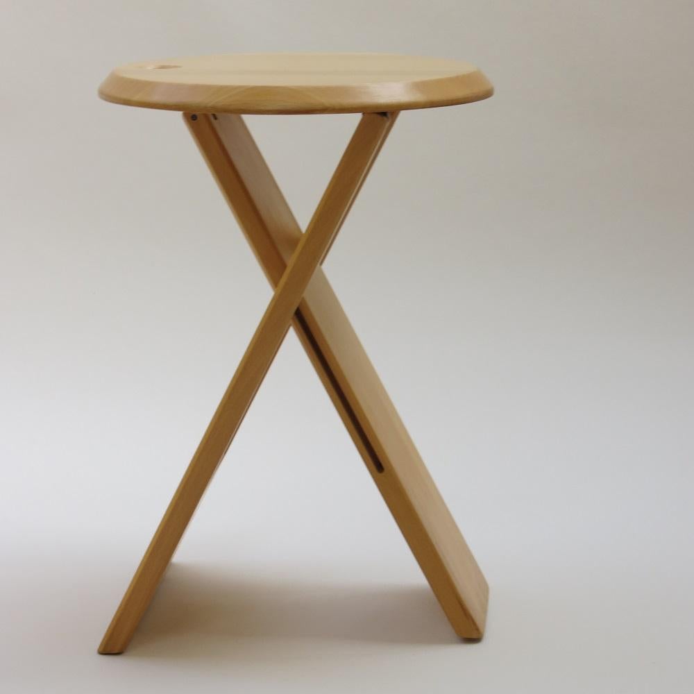 “Suzy” stool, designed by Adrian Reed 1984-1985 and manufactured by Princes Design Works Ltd. Manufactured in the late 1980s. This stool was available in two sizes, this is the shorter version.

Made from solid beech with plastic/rubber hinges.