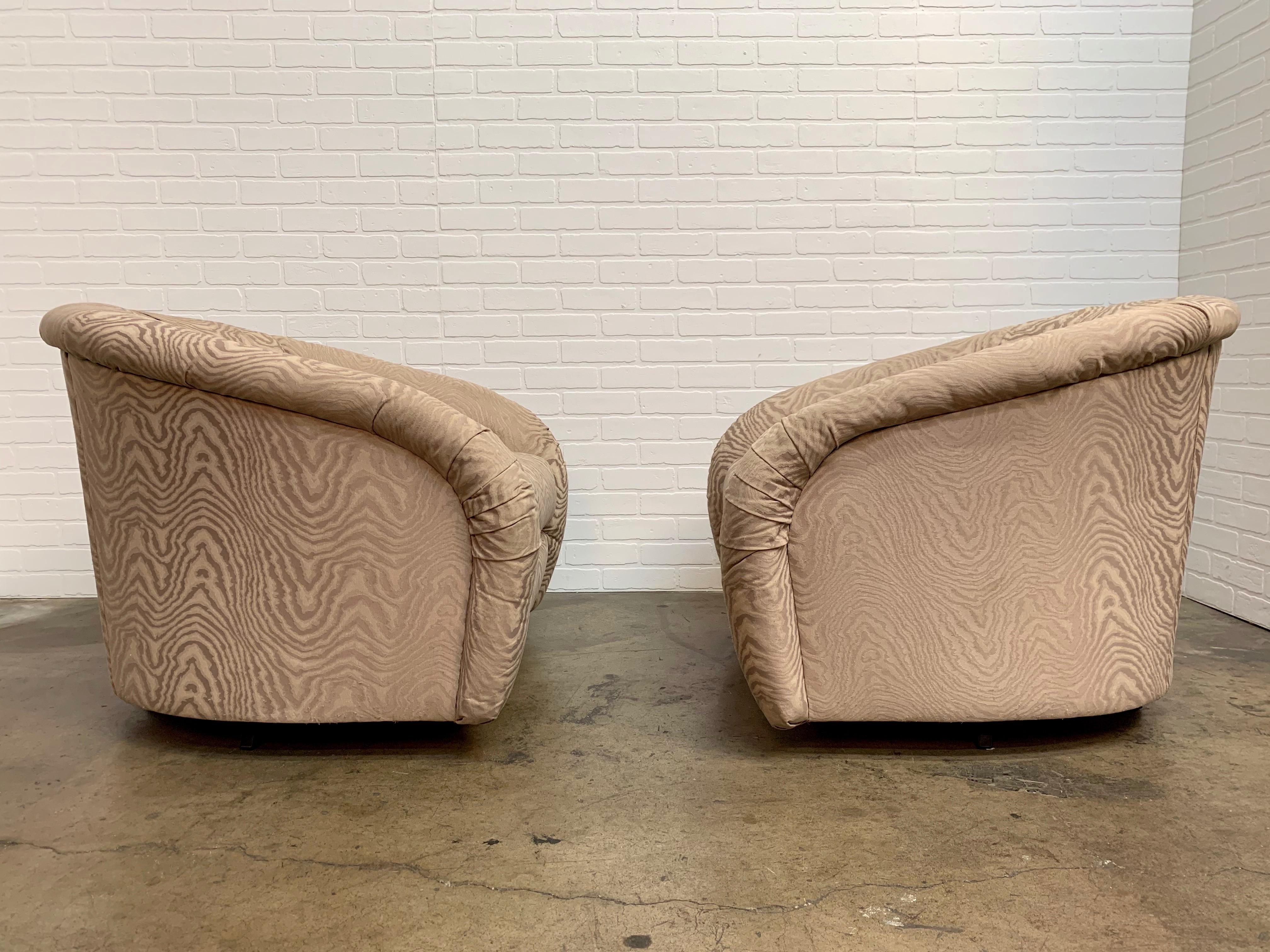 Pair of very comfortable swivel barrel lounge chairs from the early 1980s. Channel backs and smooth swivel bases. 
 New upholstery is required.