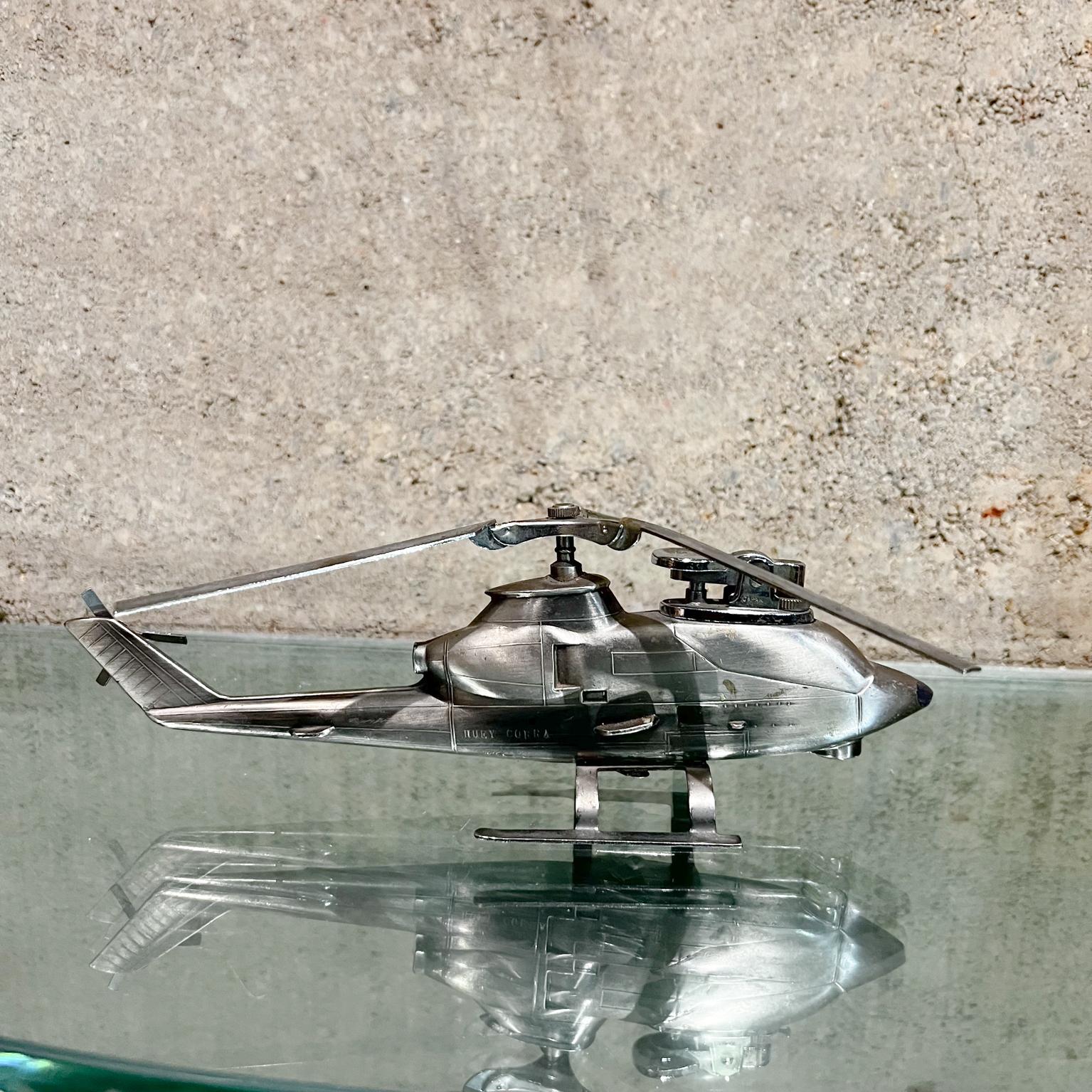 1980s Vintage table lighter chrome plated steel beautiful helicopter design.
Lighter is stamped Japan.
In the shape of a Huey Cobra Helicopter
Measures: 3 tall x 7.5 wide x 9 deep
Needs service, tested and not working at time of