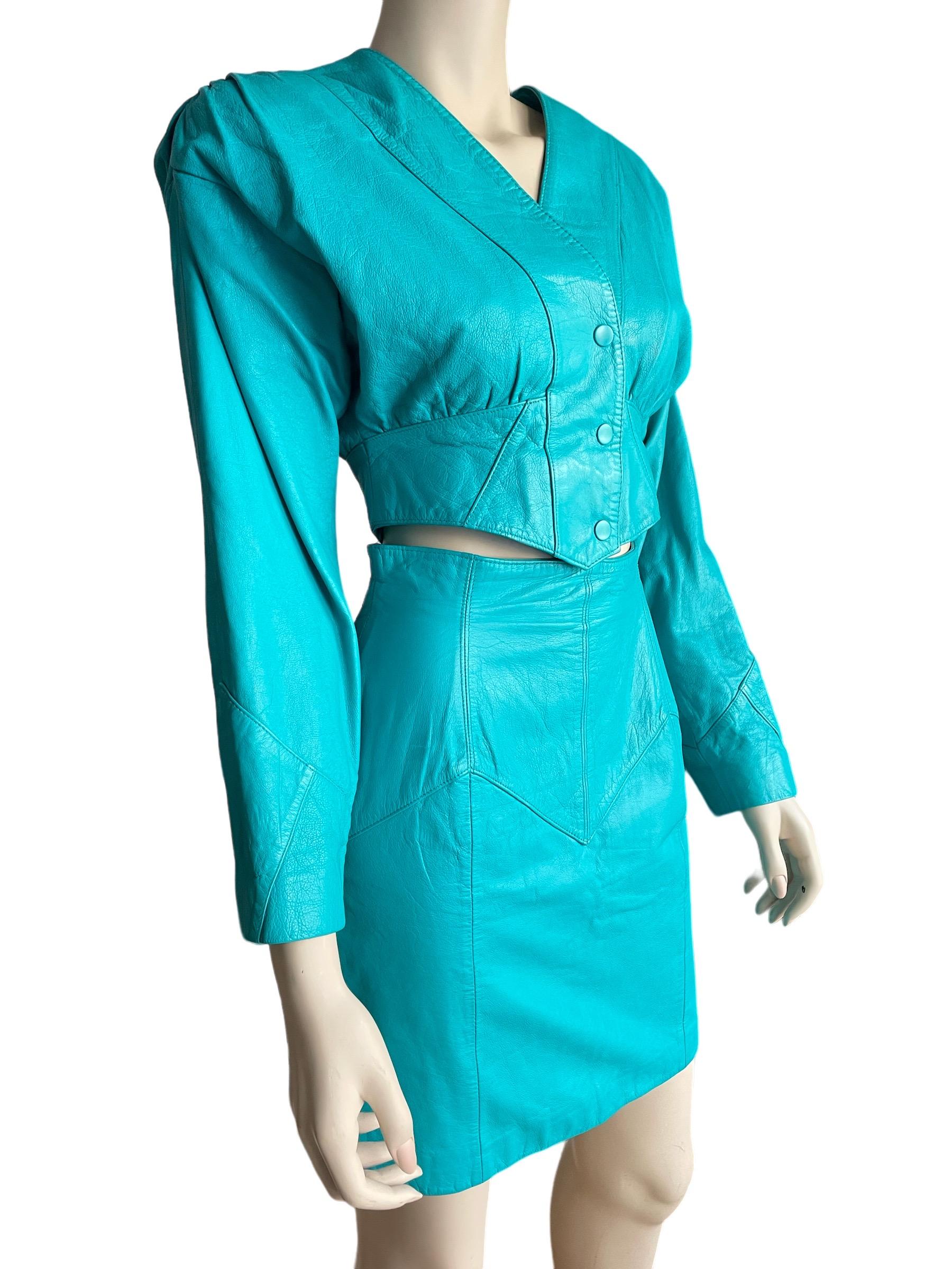 1980s Teal Leather Cropped Jacket and Skirt Set 

An amazing brightly colored teal leather high waisted mini skirt and cropped snap button jacket. A classic 80s look, shoulder pads included. 

Length of skirt: (high wasited) 18.5