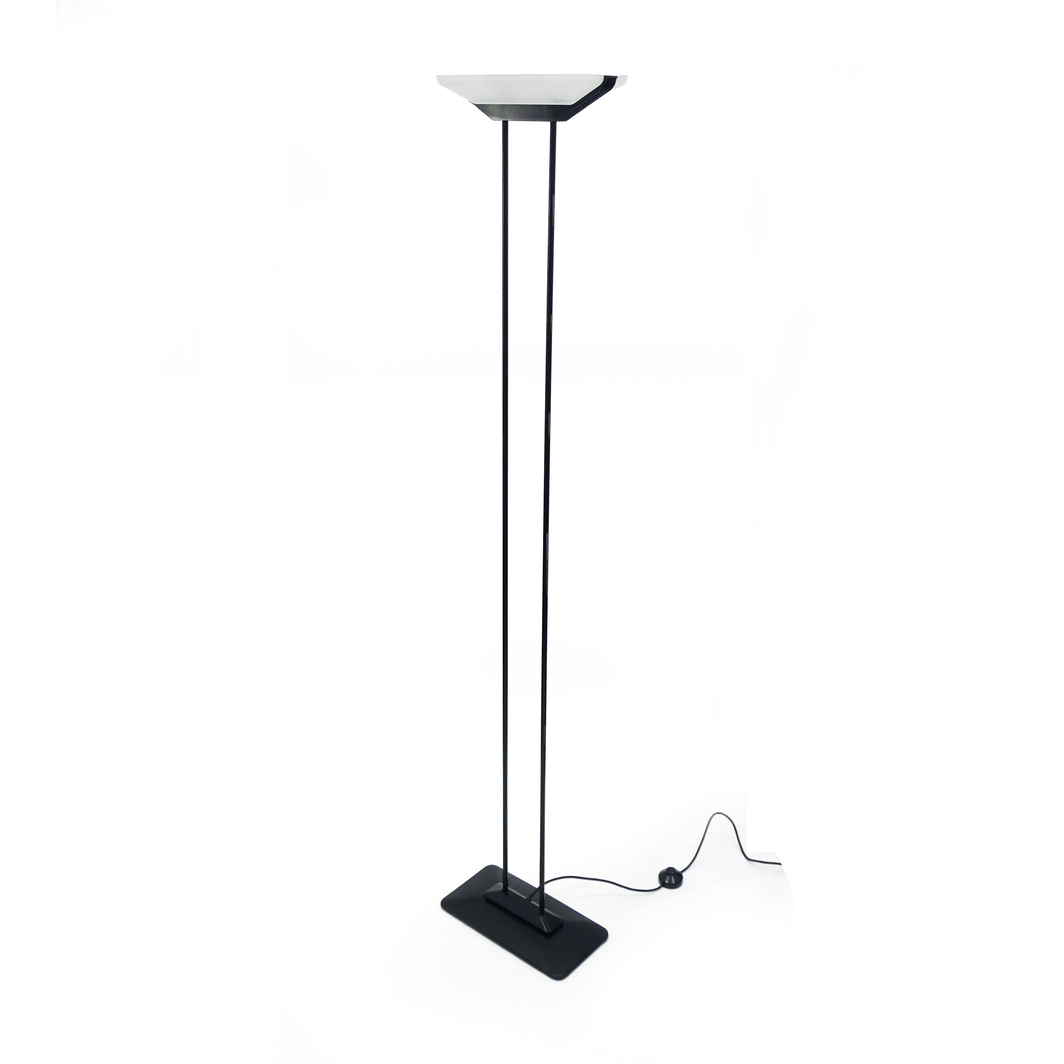 A great 1980s postmodern floor lamp by Tensor in black enameled metal. With heavy metal base and two metal columns that support a rectangular glass shade, the lamp's bulb is nestled inside the shade.

In good vintage condition with wear consistent