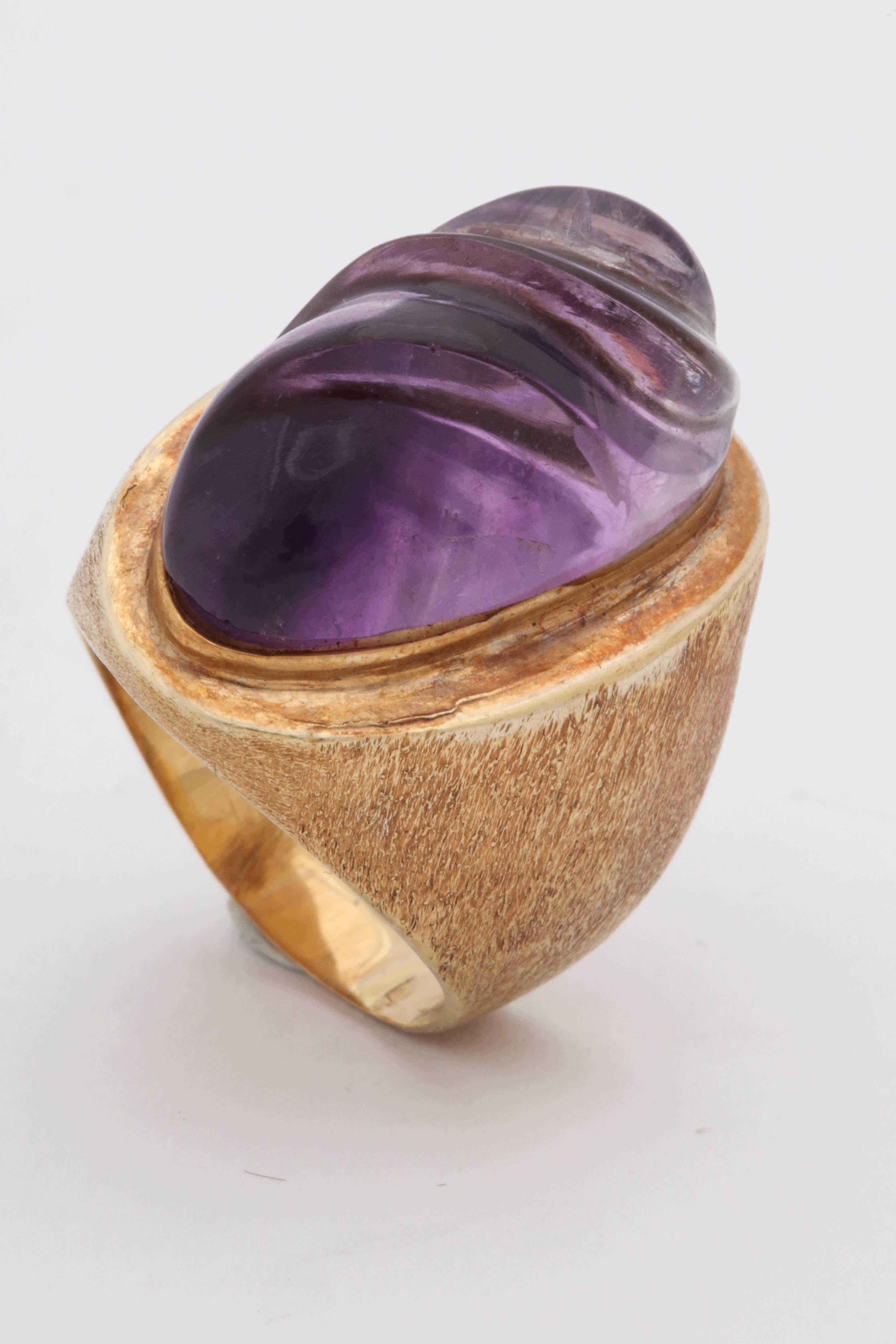 One Cocktail Ring Attributed To Burle Marx Created With A Centered Swirl Carved Amethyst Stone Measuring Approximately 25 Mm Or Approximatey 10 Carats. Rig Is Finished With A Brushed Textured Engraved Florentined Gold Created In 18kt Gold. Ring