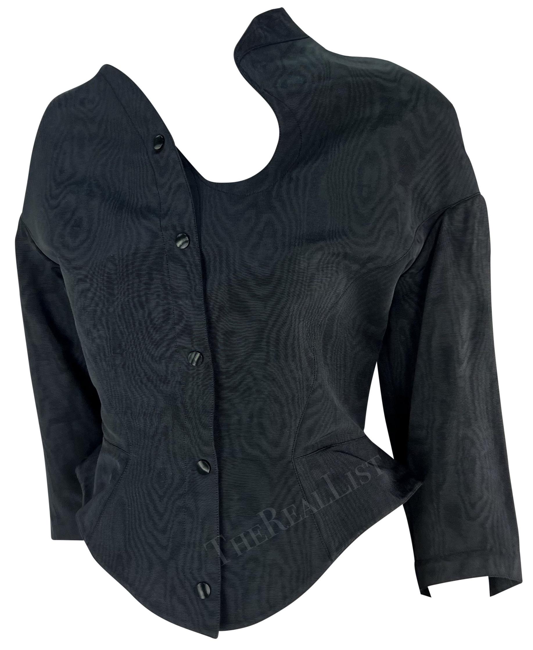 Presenting a fabulous navy blue Thierry Mugler jacket, designed by Manfred Mugler. From the late 1980s/ early 1990s, this asymmetric sculptural jacket is the perfect encapsulation of the dramatic style Mugler is infamous for. The jacket features a