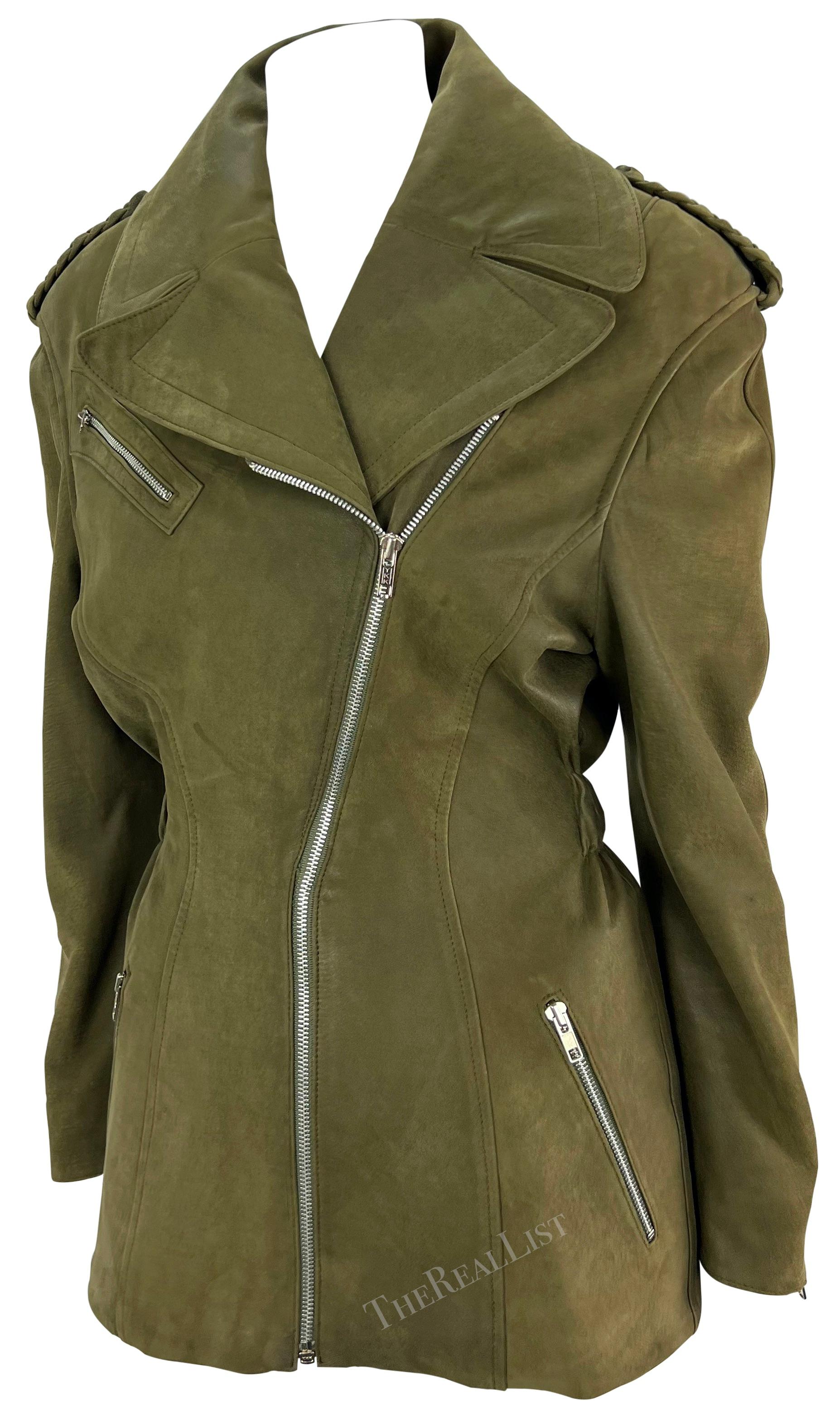 This striking olive green suede Thierry Mugler moto jacket was designed by Manfred Mugler in the the late 1980s. Crafted entirely from soft suede, this chic coat boasts a fold-over collar, braided epaulettes, and an asymmetric zipper for added