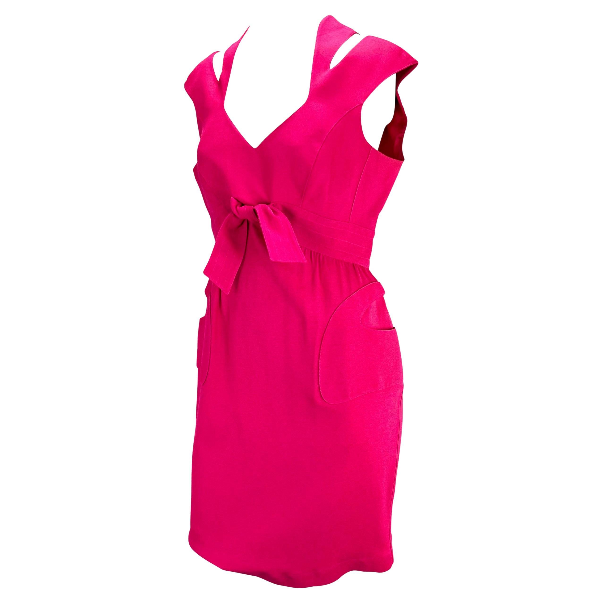 Presenting a hot, hot pink Thierry Mugler dress, designed by Manfred Mugler. From the 1980s, this dress features masterful design and tailoring. Accented with cut outs at the shoulders, a tie at the waist, and abstract pockets at the front of the