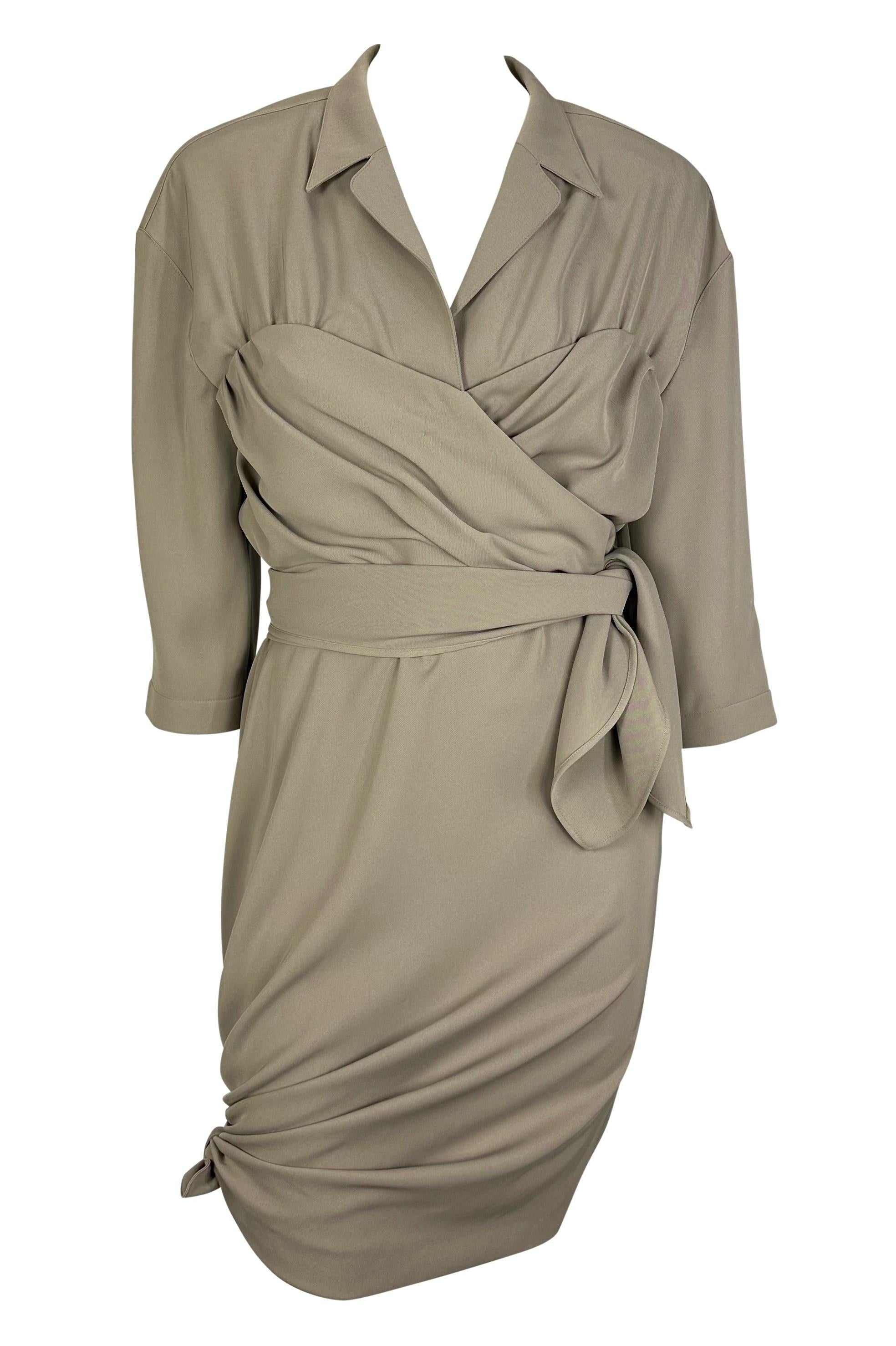 Presenting a beige Thierry Mugler collared tie dress designed by Manfred Mugler. From the 1980s, this fabulous dress features three-quarter-length sleeves, a plunging neckline, and ties around the waist and hem. This dress effortlessly highlights
