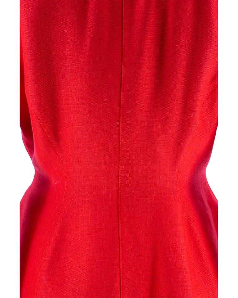 A late 1980’s Thierry Mugler asymmetric-wrap fitted panel jacket in poppy-red cotton and linen plain weave, with a deep V-neckline, organic scalloped collar and curved front hem, tapered stylised raglan sleeves with curved slit, finished with soft