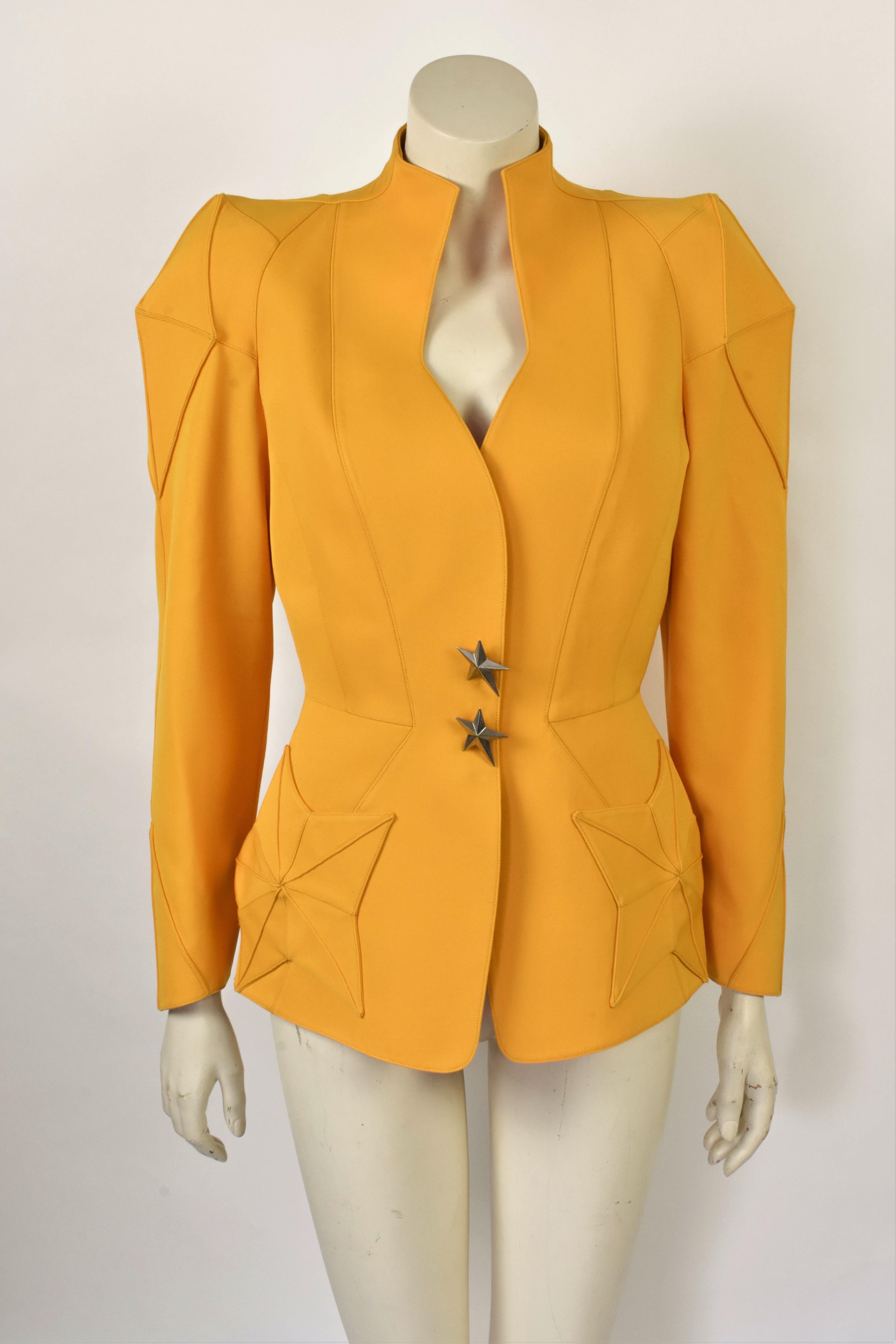 This is a lovely sculptural Thierry Mugler jacket with a strong feminine silhouette from the 80s. It has star shaped pockets and two Mugler star brooches serving as buttons. The star shape is favorited by Mugler and is most know from his best