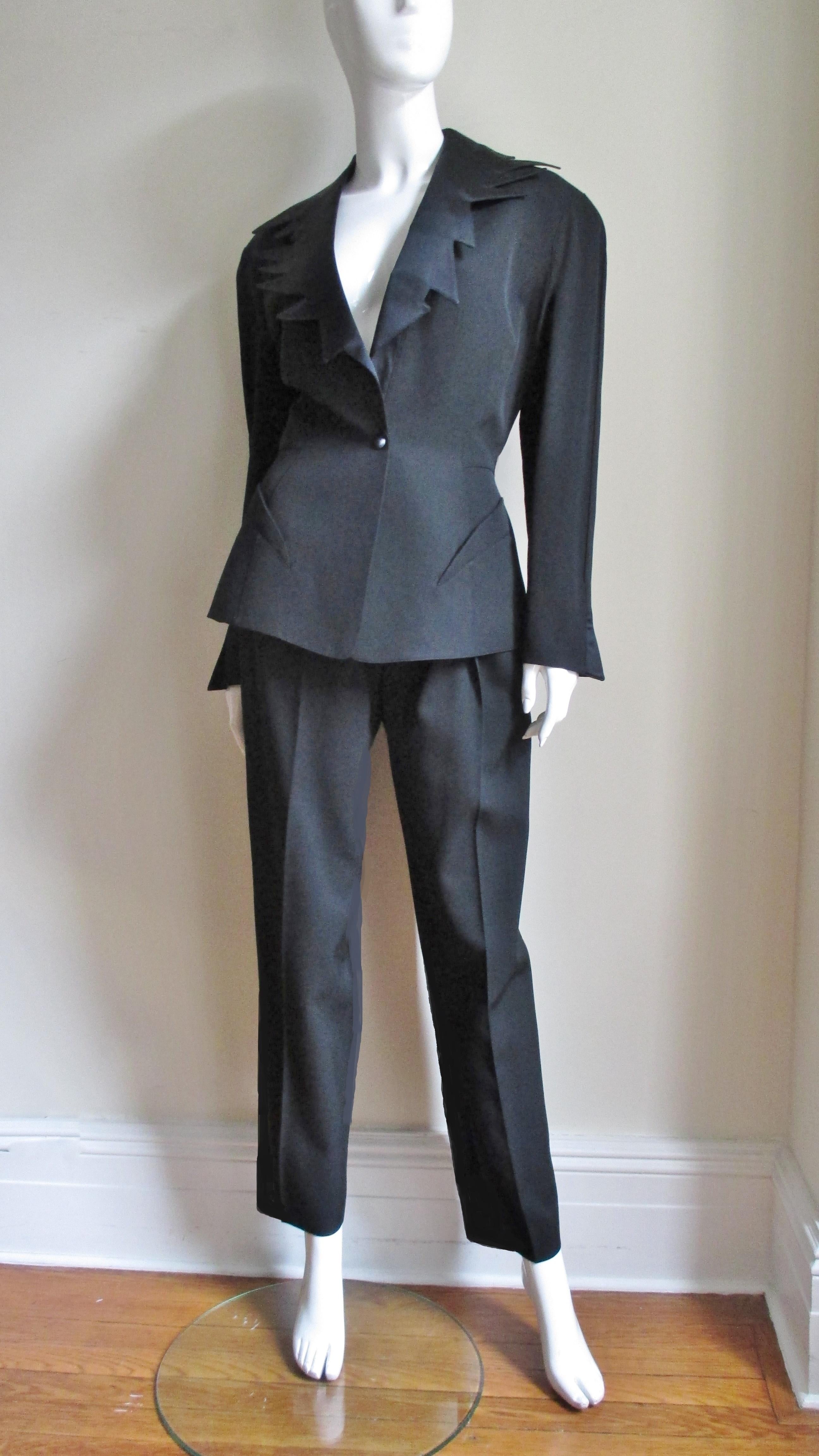 A fabulous 2 piece tuxedo from Thierry Mugler.  The jacket is incredible with a zig zag edged silk satin collar plus the signature fitted waist and seaming Mugler is known for.  It has curved front pockets, flared slit cuffs, shoulder pads and 1