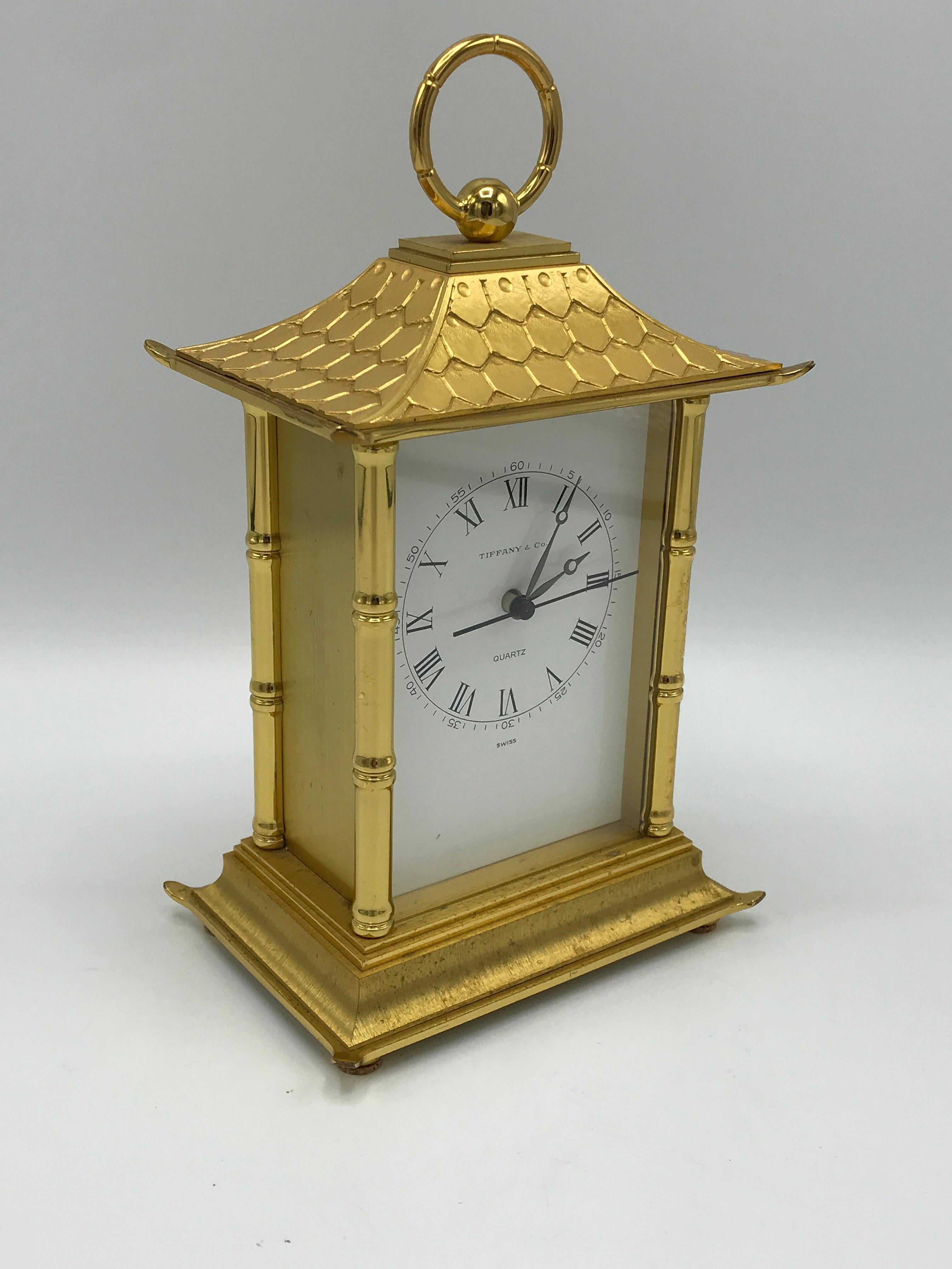 Offered is a stunning and extremely rare, 1980s Tiffany & Co. solid-brass pagoda clock. The piece has a stunning allover faux-bamboo motif, with heavy detailing. The scalloped 'shingled' top is incredible as well. All is in working, fully