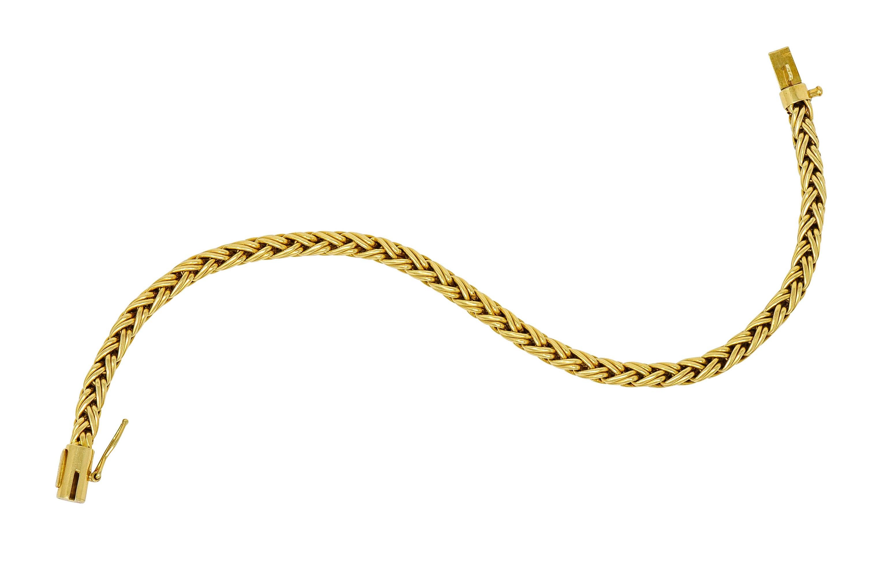 Bracelet is designed as a polished gold woven wheat chain

Completed by a barrel clasp with a figure eight safety

Fully signed Tiffany & Co.

Stamped 750 for 18 karat gold

Circa: 1980s

Length: 7 3/8 inches

Width: 3/16 inch

Total weight: 12.6