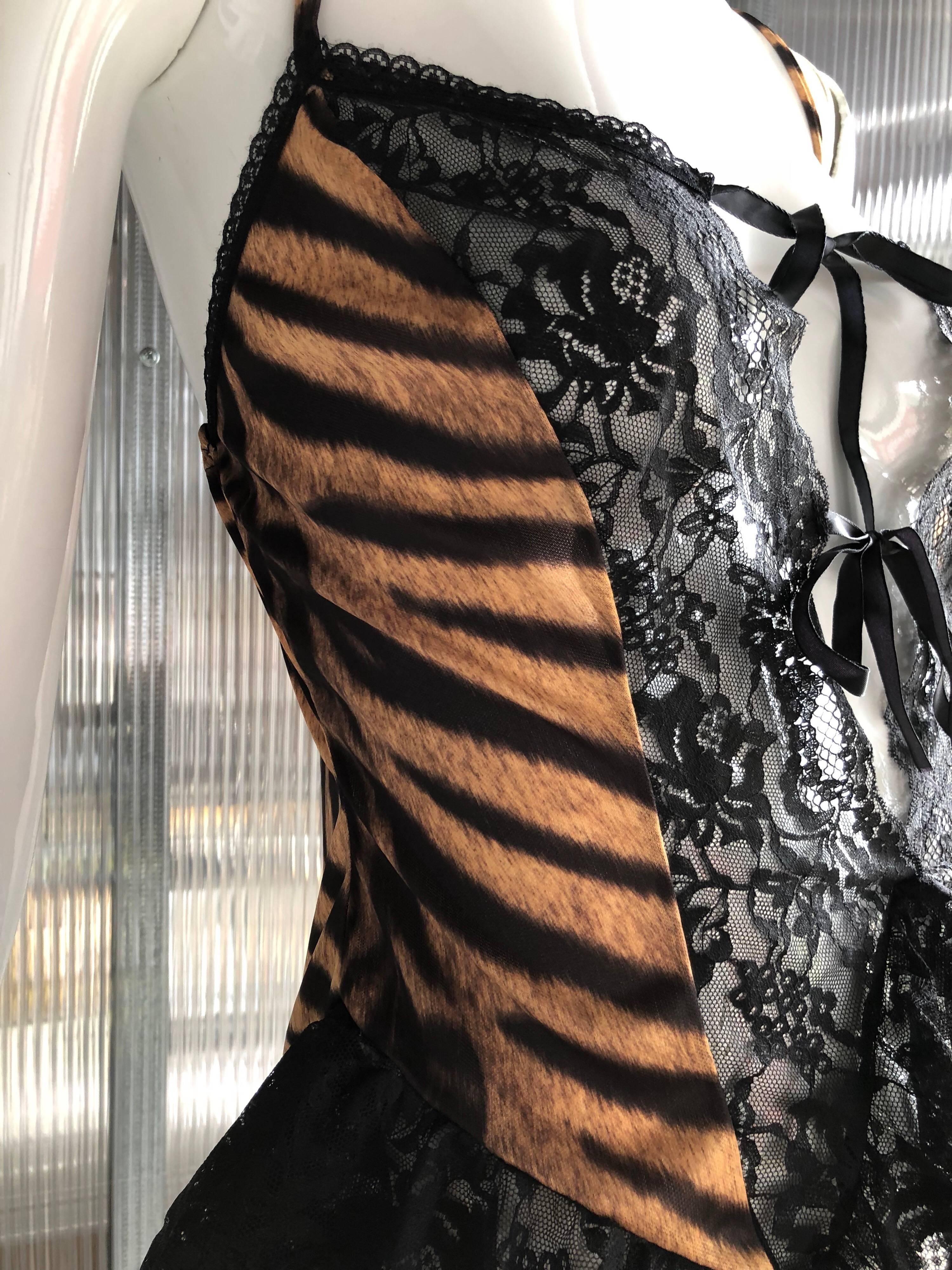 1980s Made in London from Fenwicks department store on Bond Street. This stretch jersey print tiger stripe lingerie top features black lace trimmings and ribbon tie front. 
Garters are optional and fits a perfect size medium. 