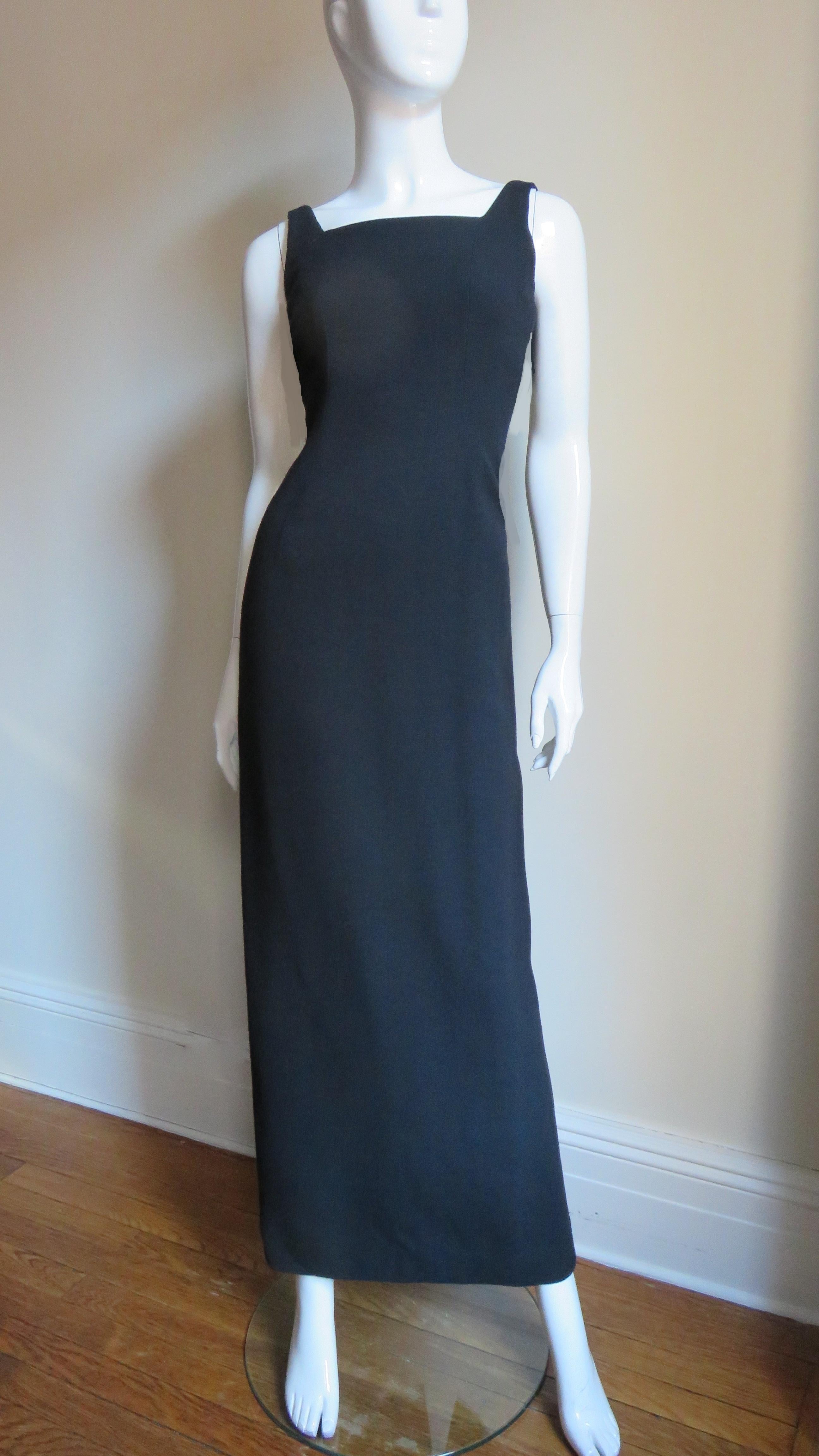 A fabulous black full length dress from Todd Oldham.  It has a square front neckline and is backless with the exception of ties at the waist. The skirt falls straight to the hem and has a back kick pleat. The gown is lined in black silk and has a