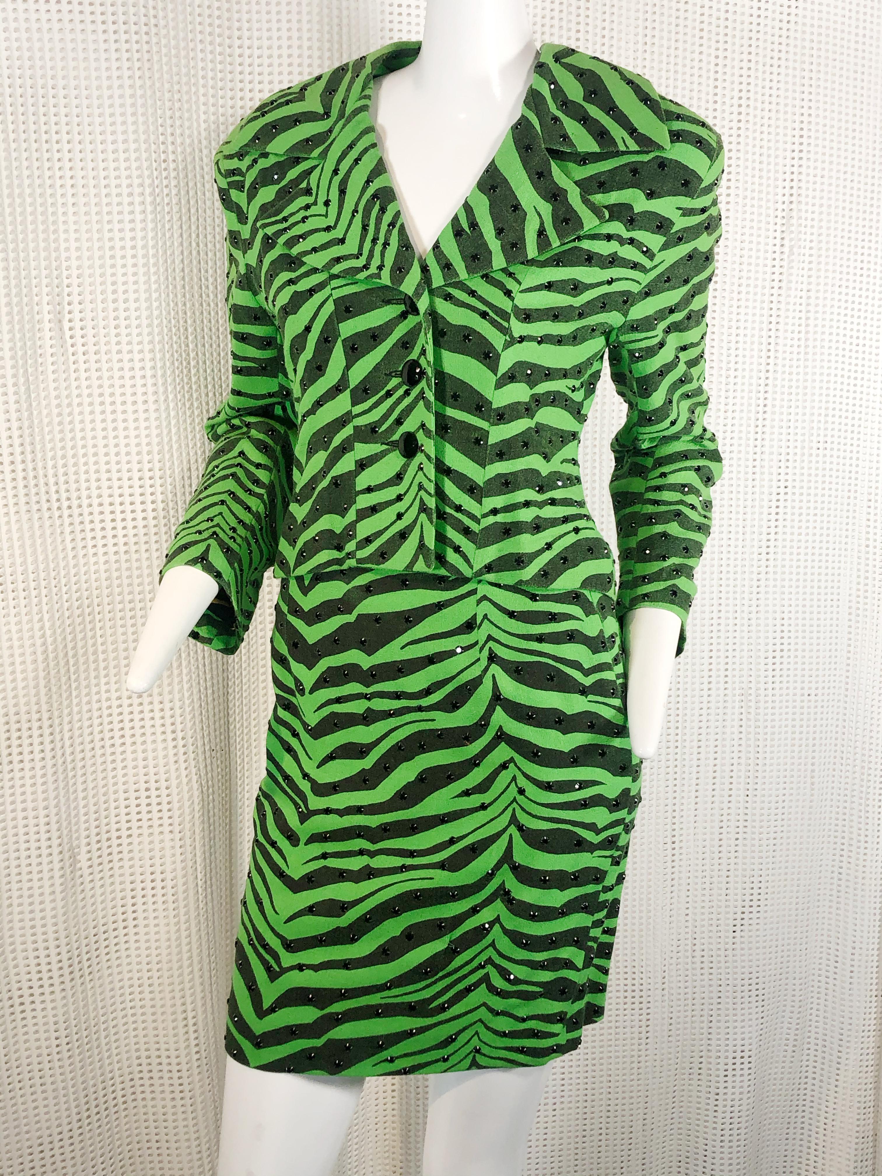 A 1980s Todd Oldham electric green and black zebra print wool suit. Lined in yellow zebra print charmeuse.  Black rhinestone prong set studs scattered over entire suit.   Black glass buttons.