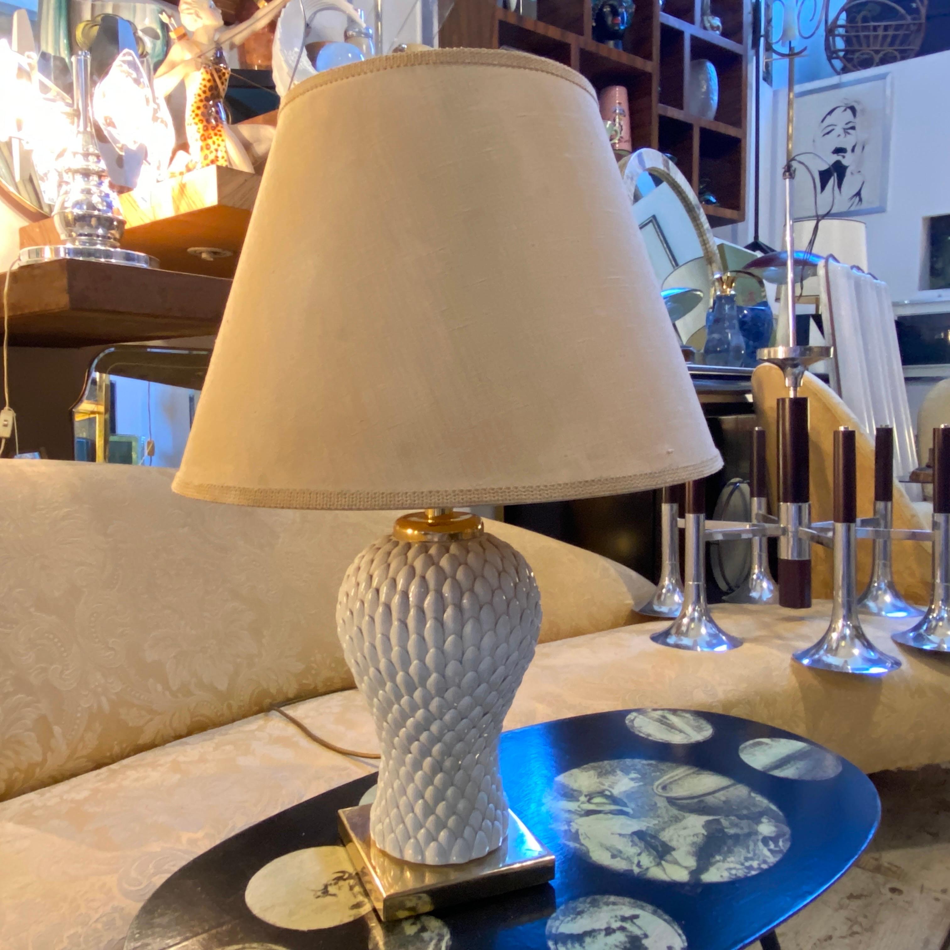An high quality table lamp designed and manufactured in Italy in the Eighties, in perfect condition with original lampshade with normal signs of age. Base side dimensions is cm 18, it works both 110-240 volts and needs regular e27 bulb.
The 1980s