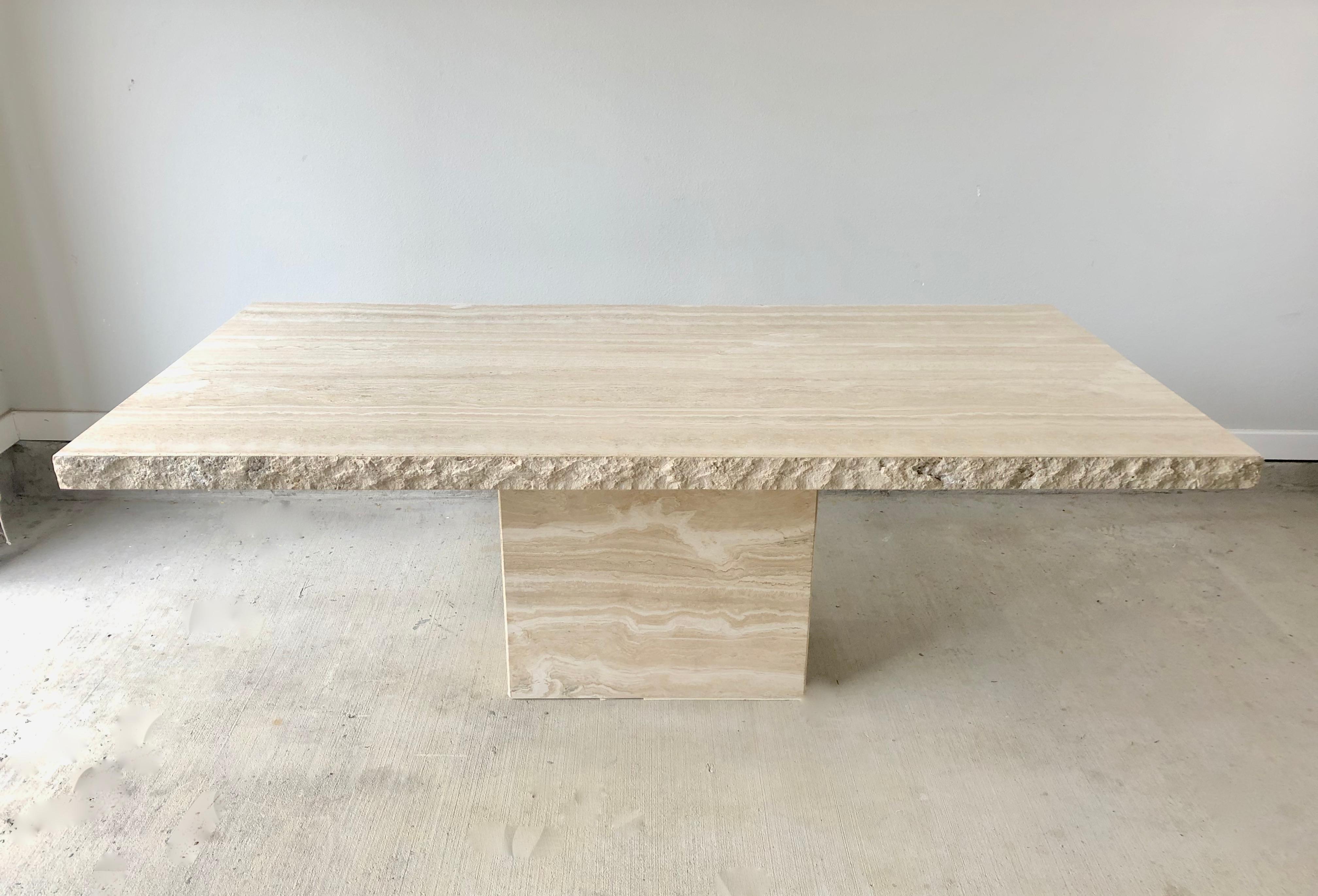 Massive Italian travertine dining table with sculpted live edge.