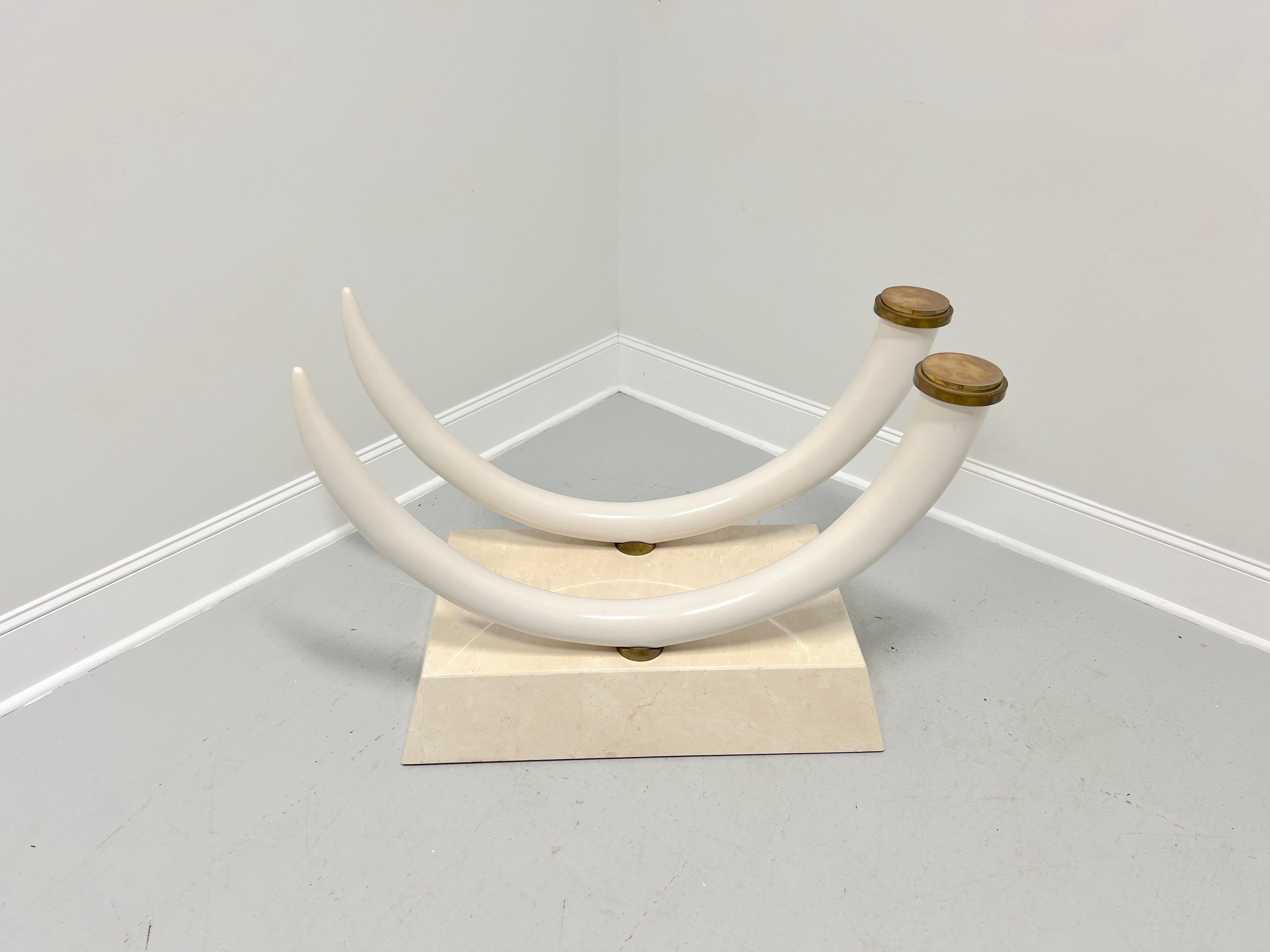 A Contemporary style dining table pedestal base, unbranded. Solid travertine base in a rectangular shape supporting composite faux elephant tusks with decorative brass disks at base of tusks and brass accents where tusks meet the base. Ready for