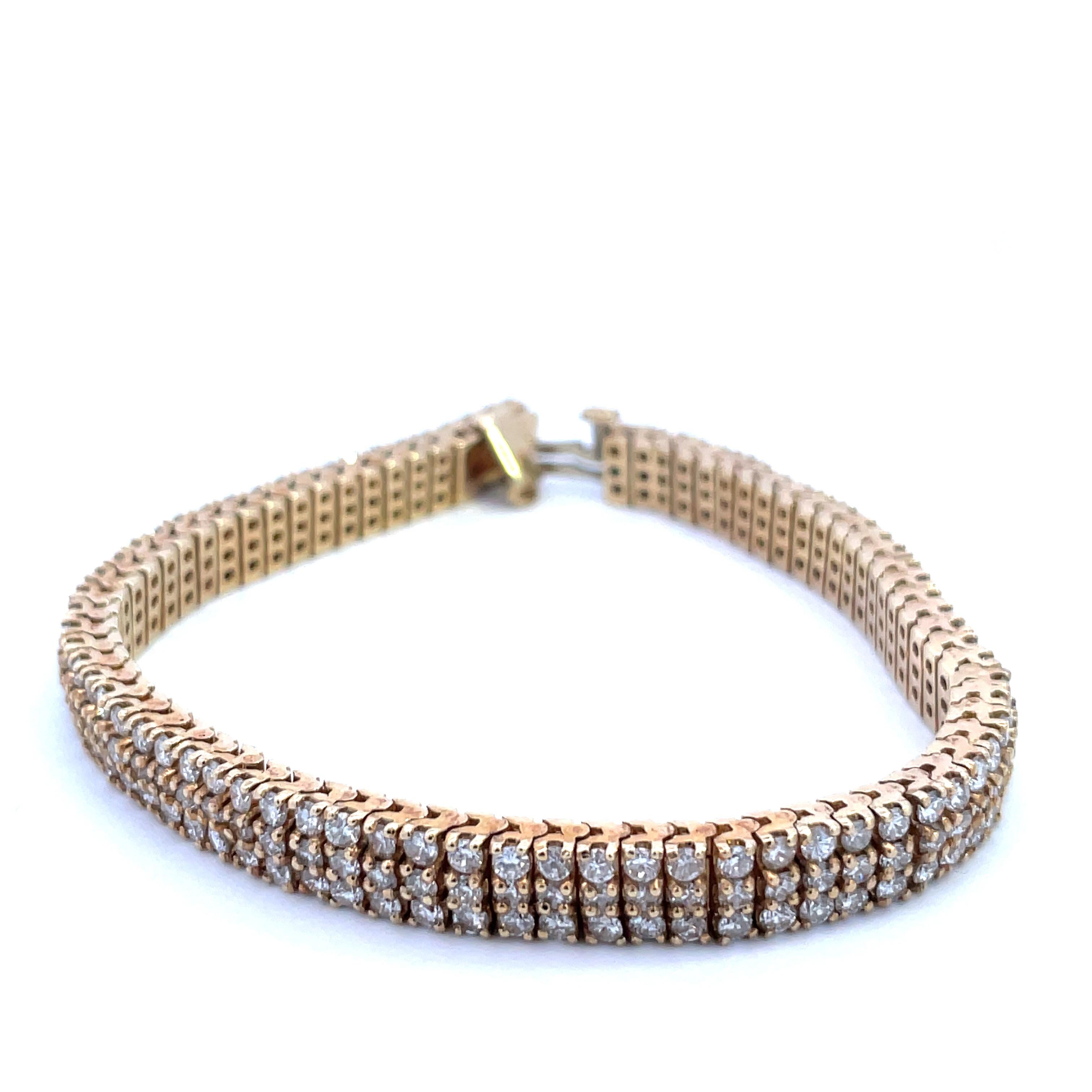 What an absolutely gorgeous 14K yellow gold triple- row diamond studded bracelet! This show-stopping bracelet features 3 rows of glimmering diamonds set in 14K yellow gold. Can you imagine showing this bracelet off to your friends? Their eyes