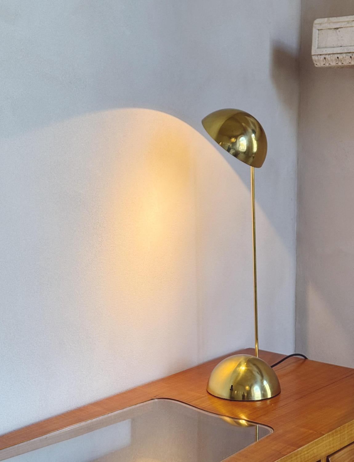 An iconic 1980s Italian design piece, the Bikini desk lamp, in brass, made by Tronconi, Milano. A simple, extremely pleasing design with an exceptionally heavy semi spherical base. It casts a wonderful light when turned on. Good working order with
